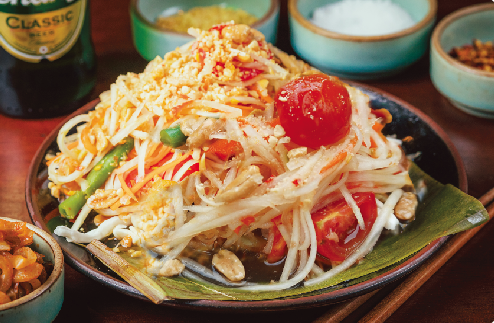 Fresh Thai papaya salad with cherry tomatoes and peanuts