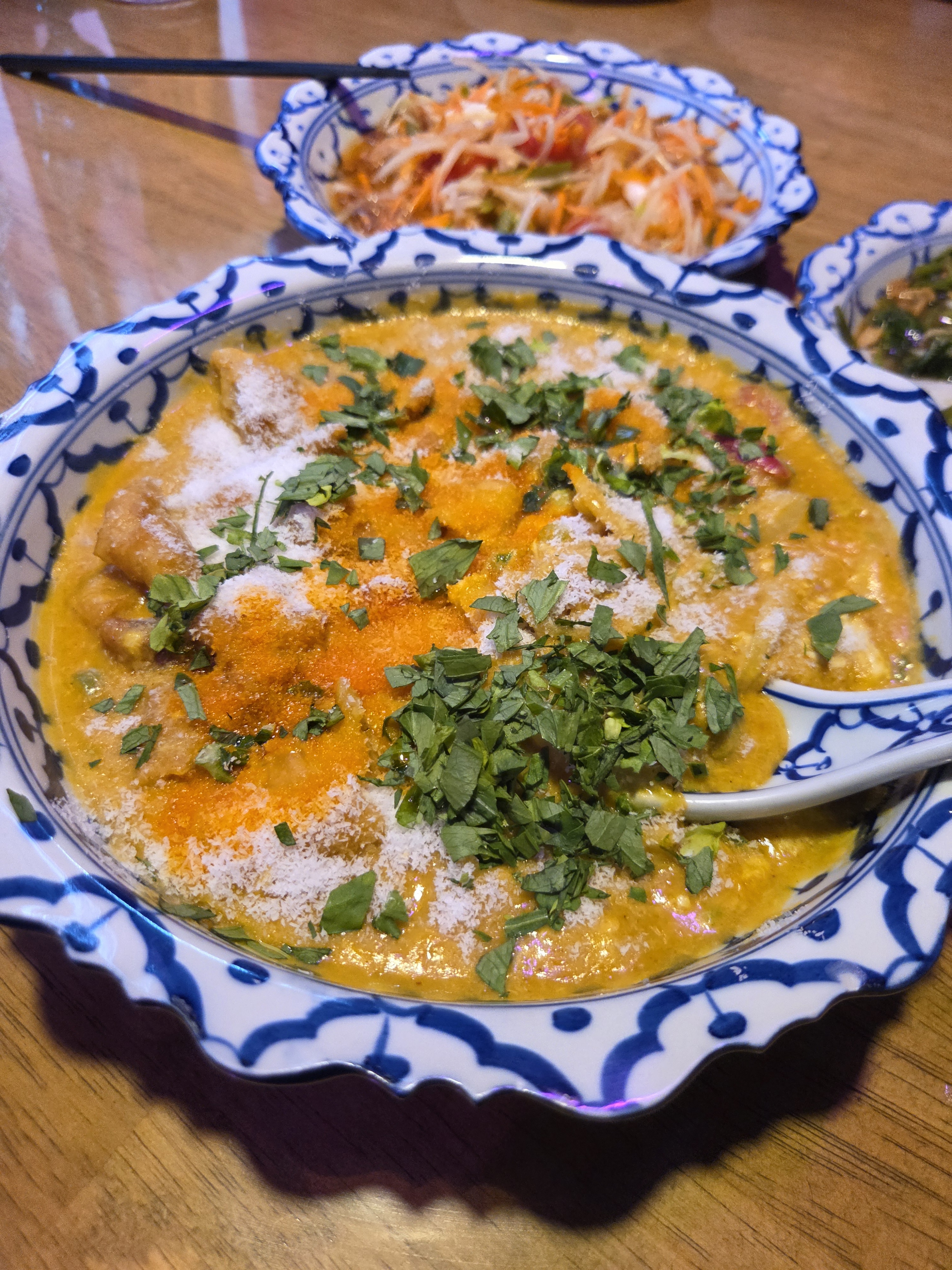 Aromatic curry served in traditional patterned Thai ceramic bowl
