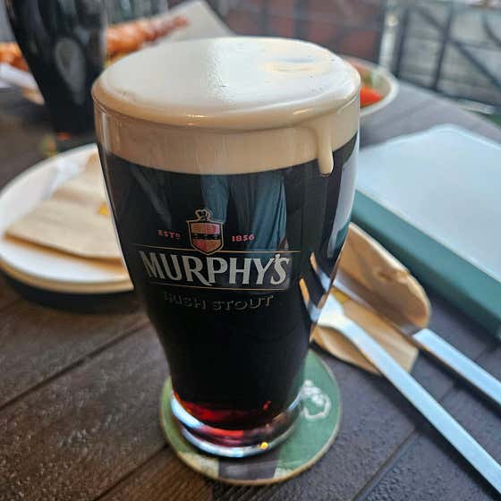 Pint glass filled with Murphy's Irish Stout topped with thick creamy foam