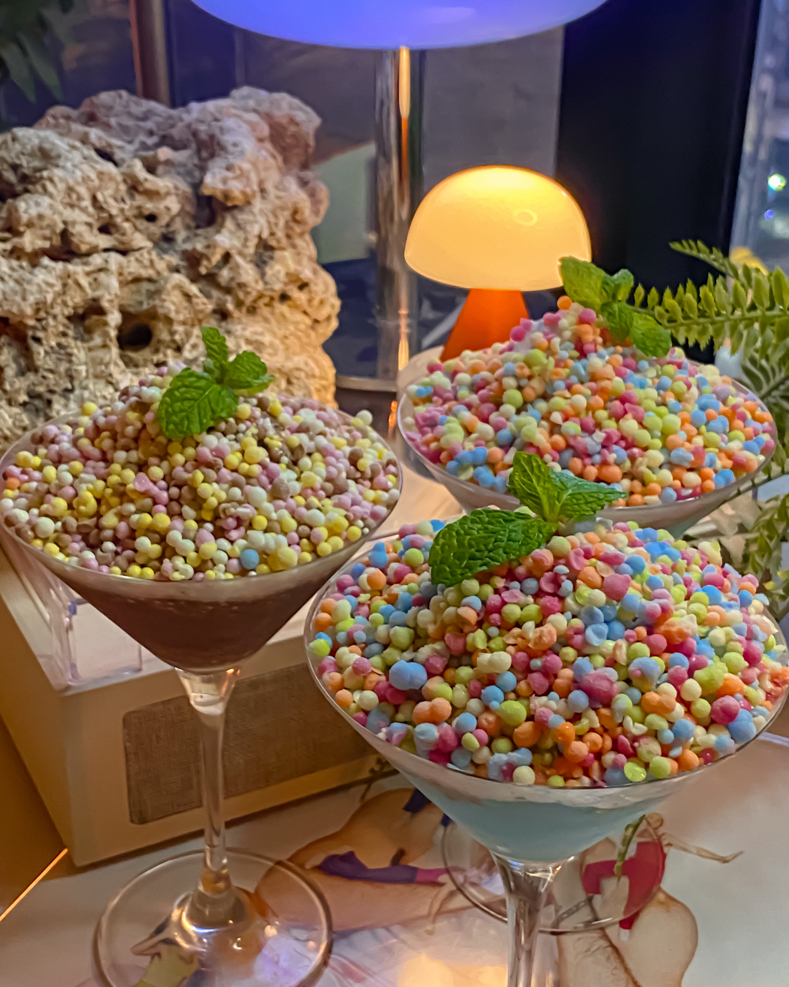 Signature Dippin' Dots ice cream cocktails in martini glasses garnished with mint