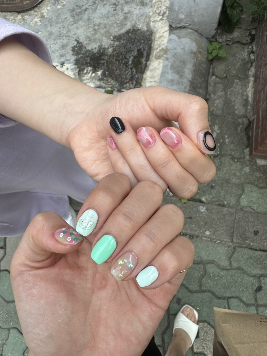 Artistic seasonal nail art set with pastel mint and accent charms