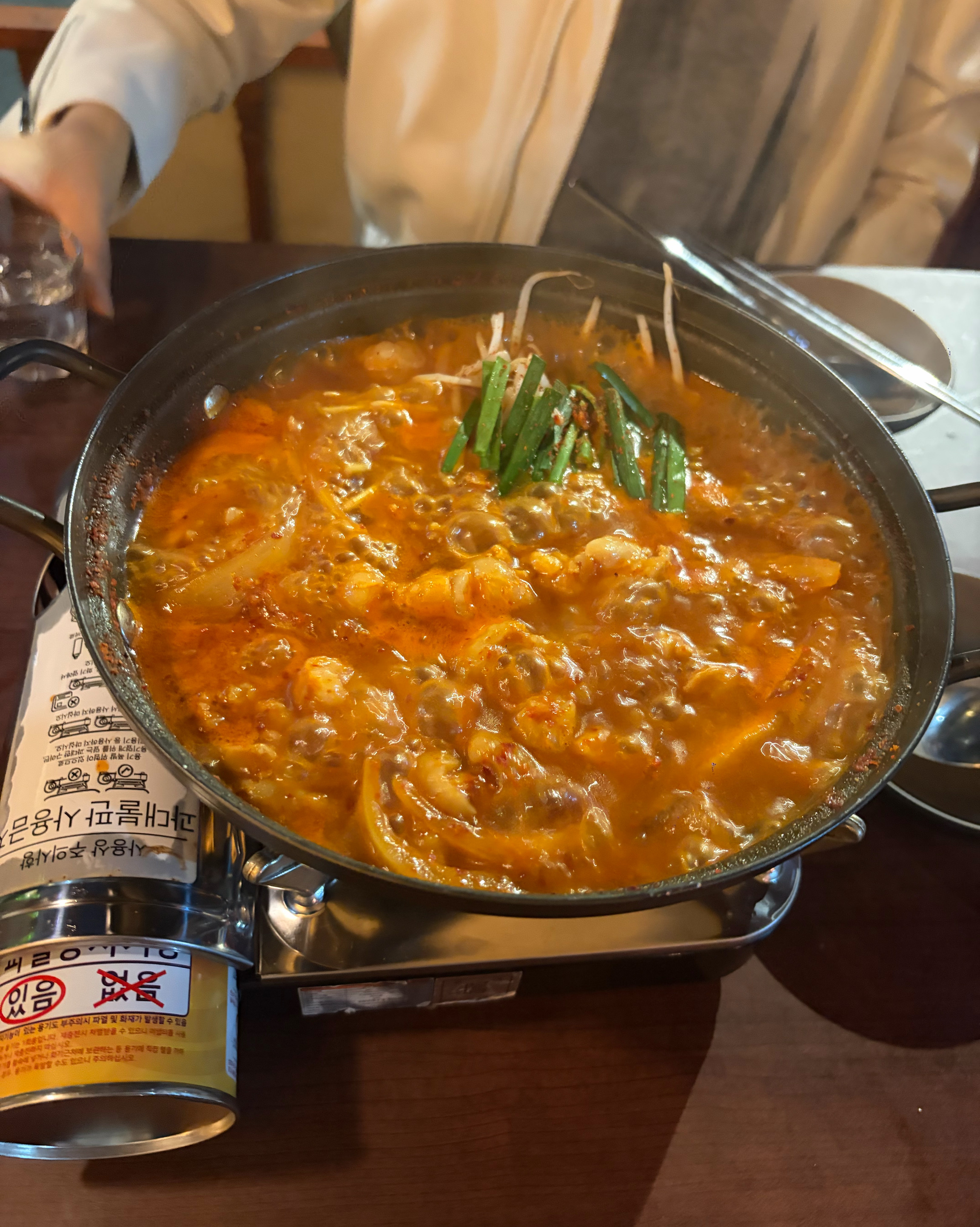 Bubbling spicy Hanwoo beef tripe and chicken stew served in a hot pot