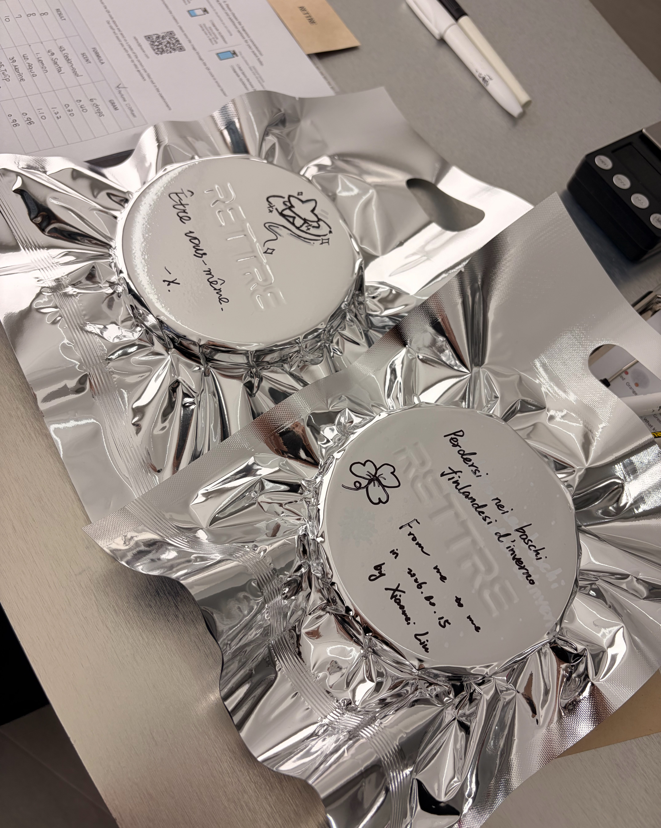 Silver vacuum-sealed fragrance package with handwritten notes at Rettre Seoul Forest