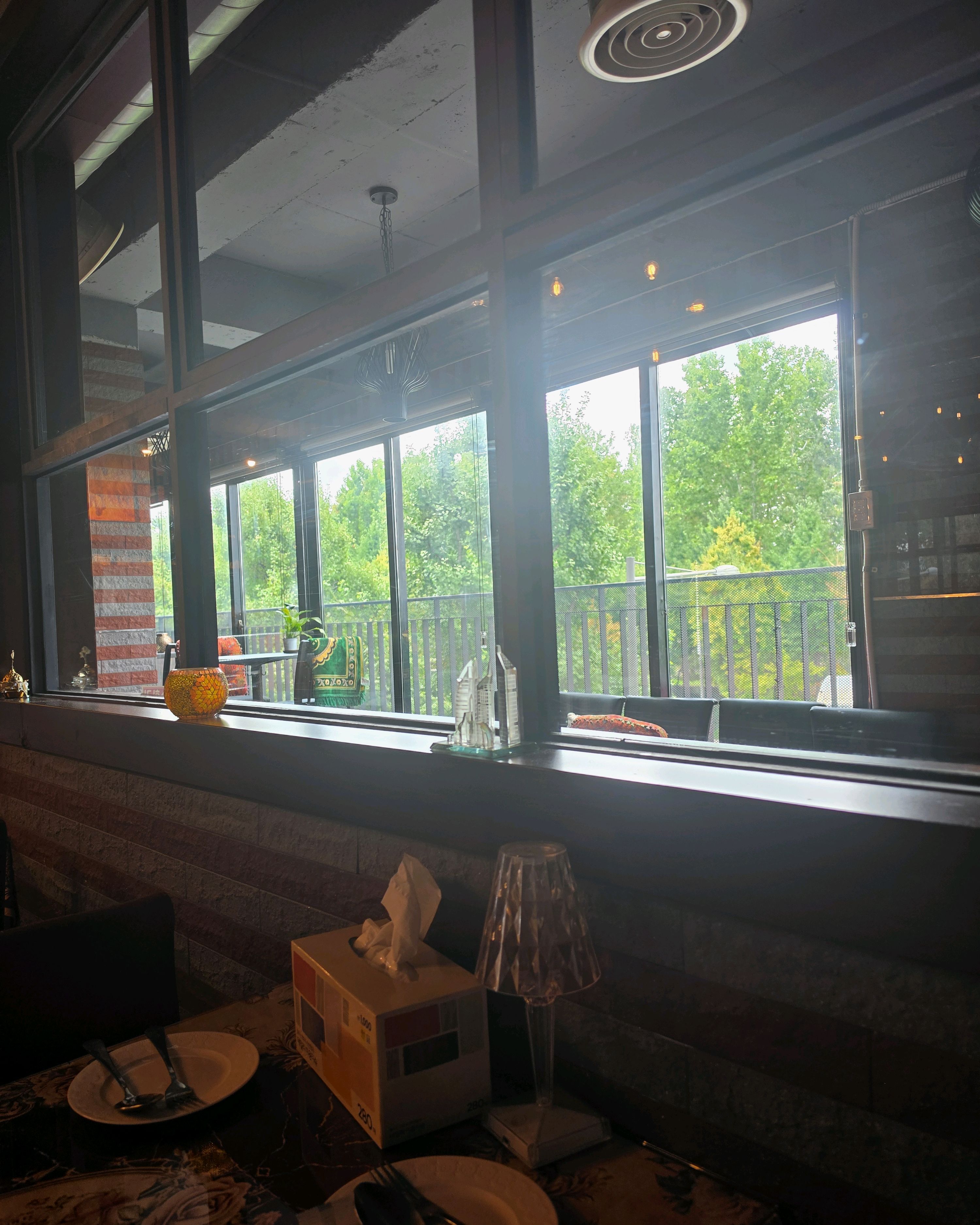 Daylight window seating area looking out to green tree tops along Noksapyeong