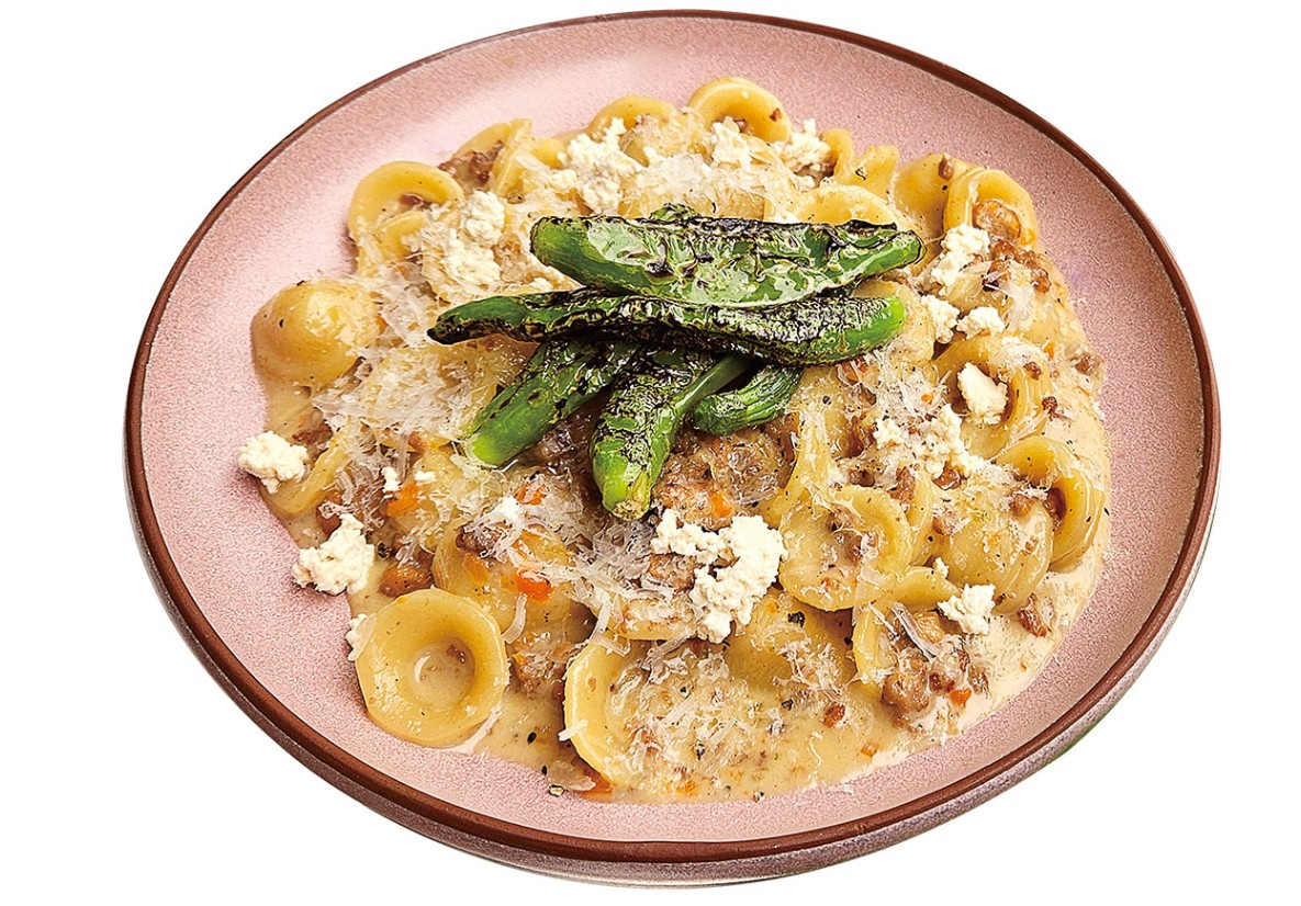 Orecchiette pasta served with savory meat sauce and charred green peppers