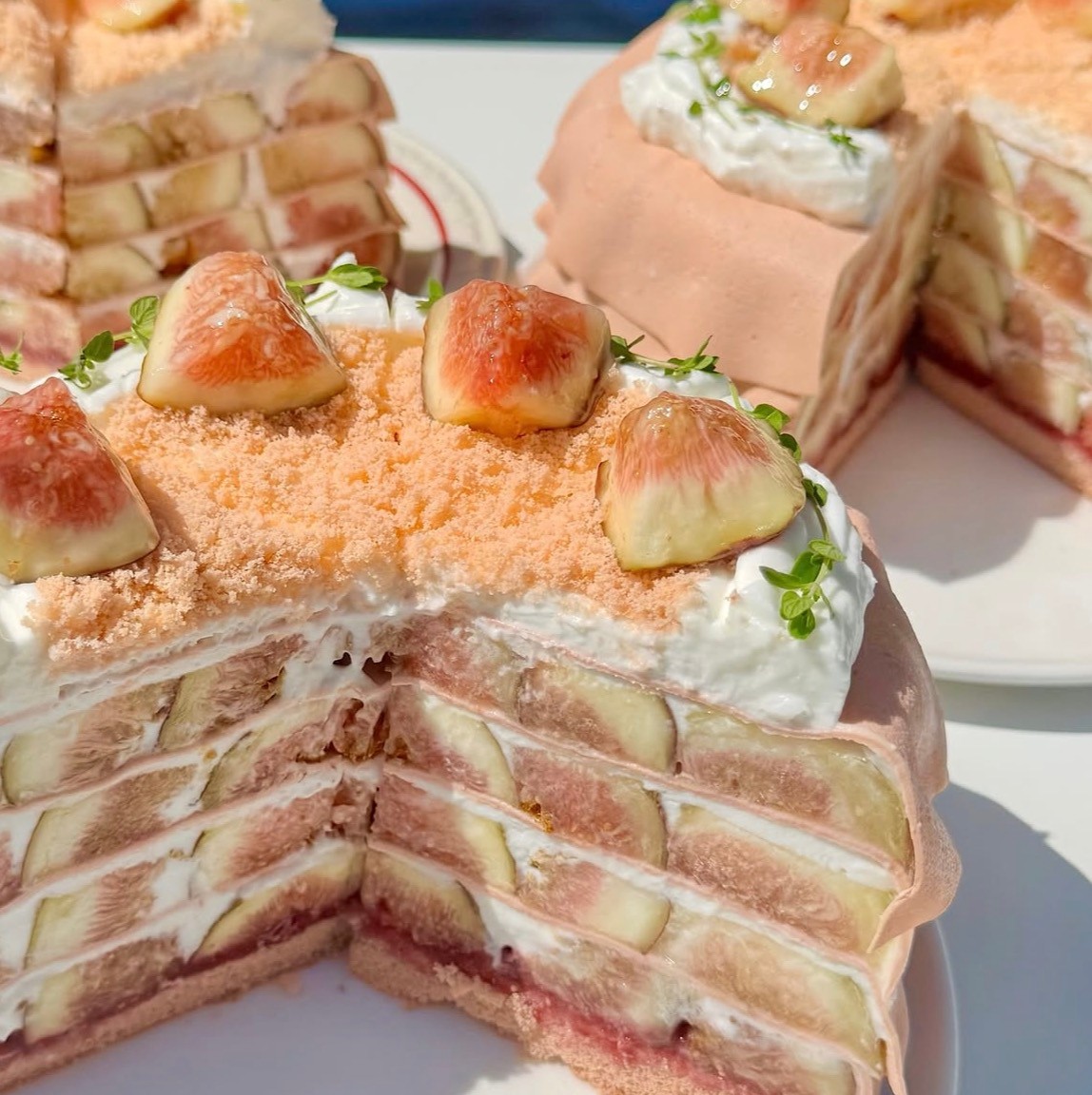 Layered fig cream cake cross section on plate