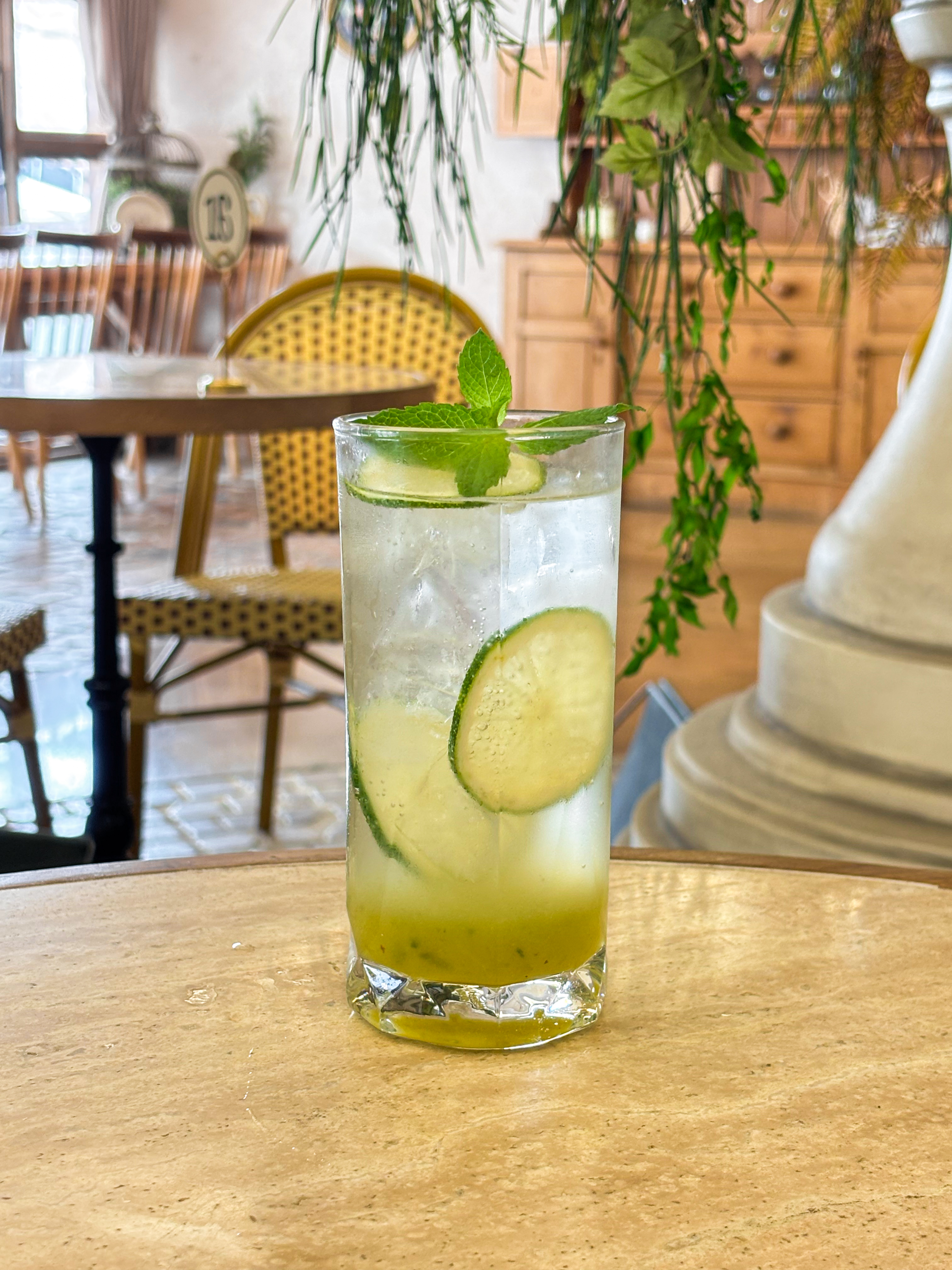 A refreshing lime mojito drink sits on a cafe table at Cercle Hannam.
