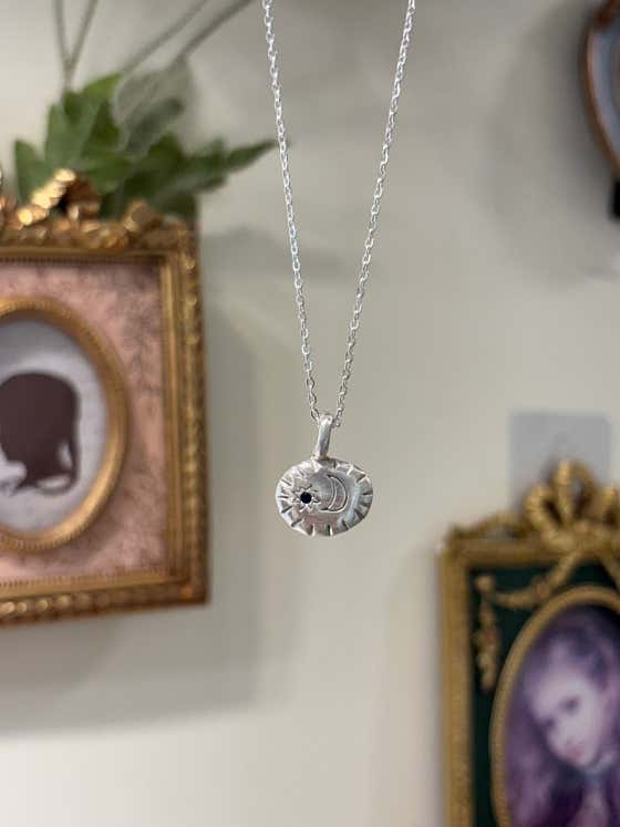 Handcrafted silver necklace with moon and star design
