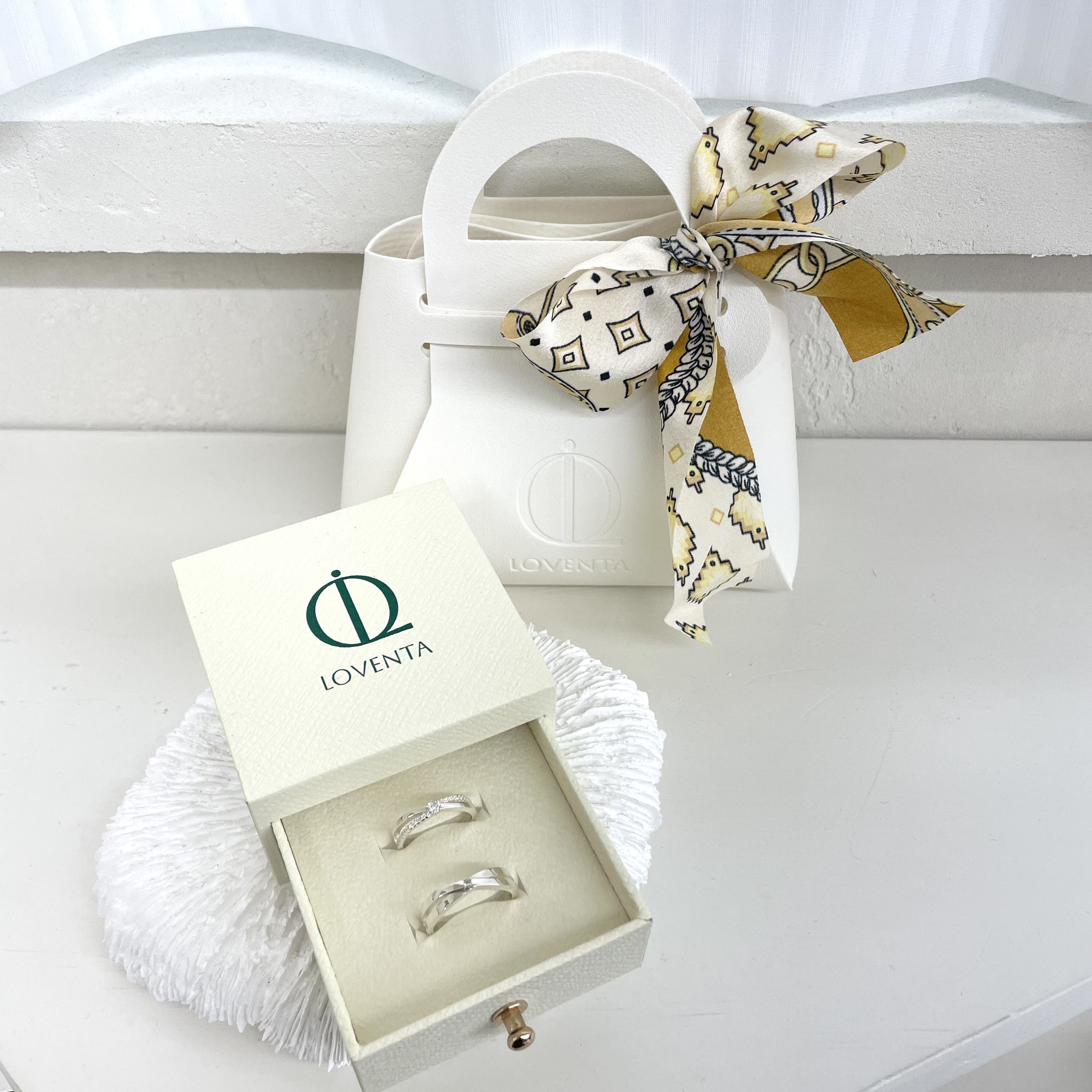 LOVENTA branded ring box and gift bag tied with patterned silk ribbon