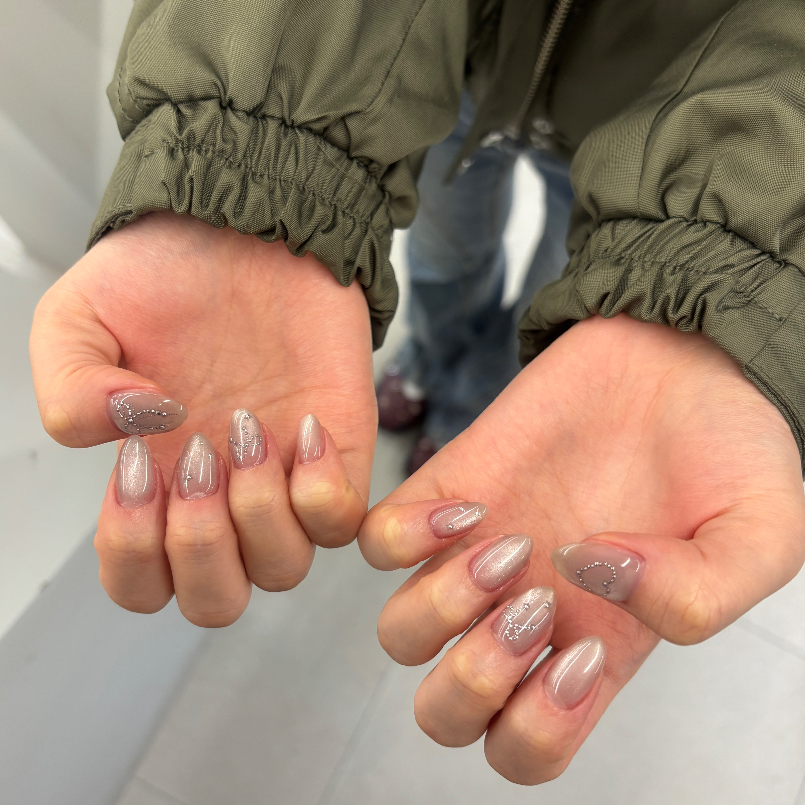 Nude shimmer polish with minimalist silver detailing