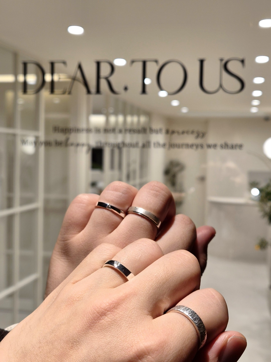 Hands wearing rings at the window