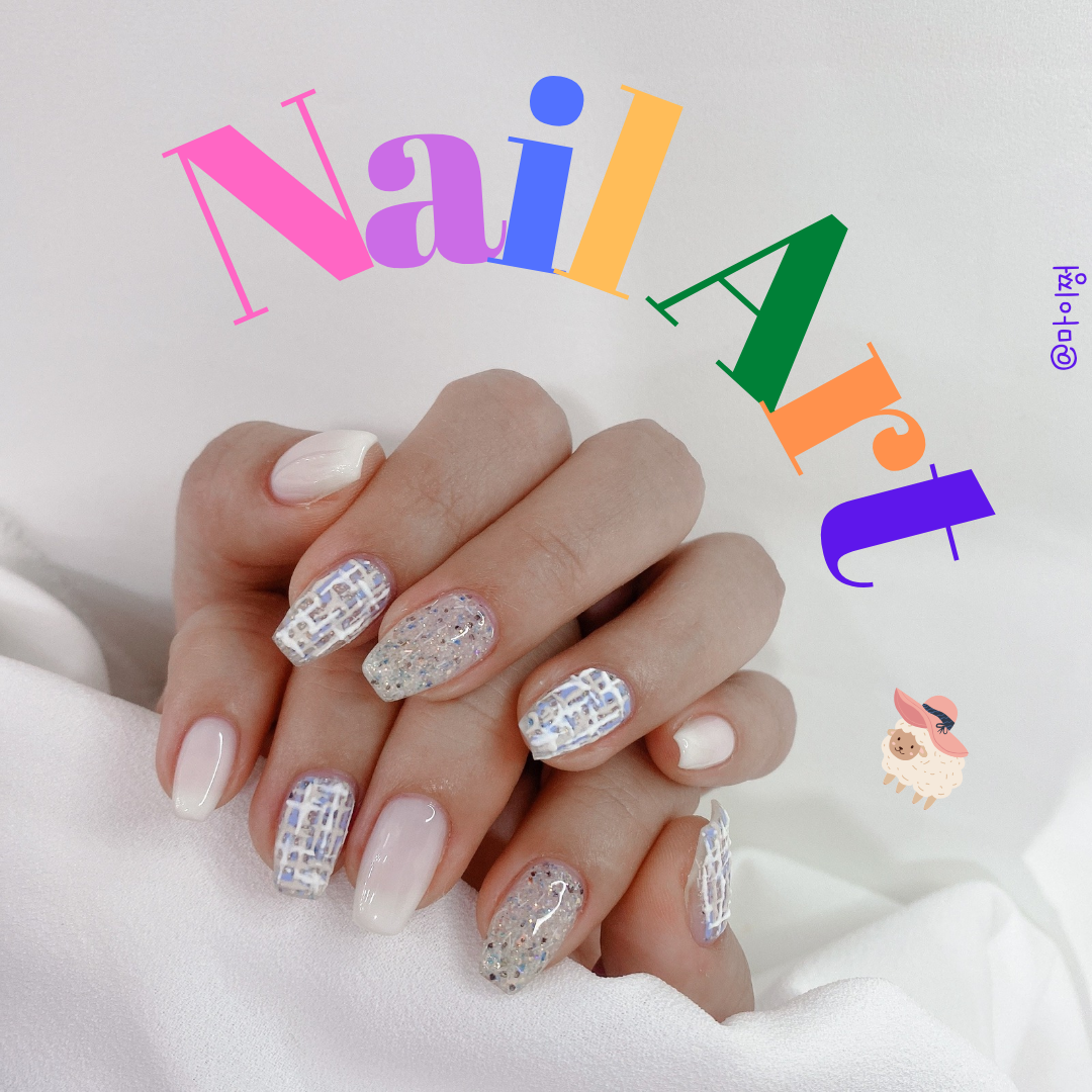 Manicured hands displaying tweed pattern and glitter nail art against soft fabric