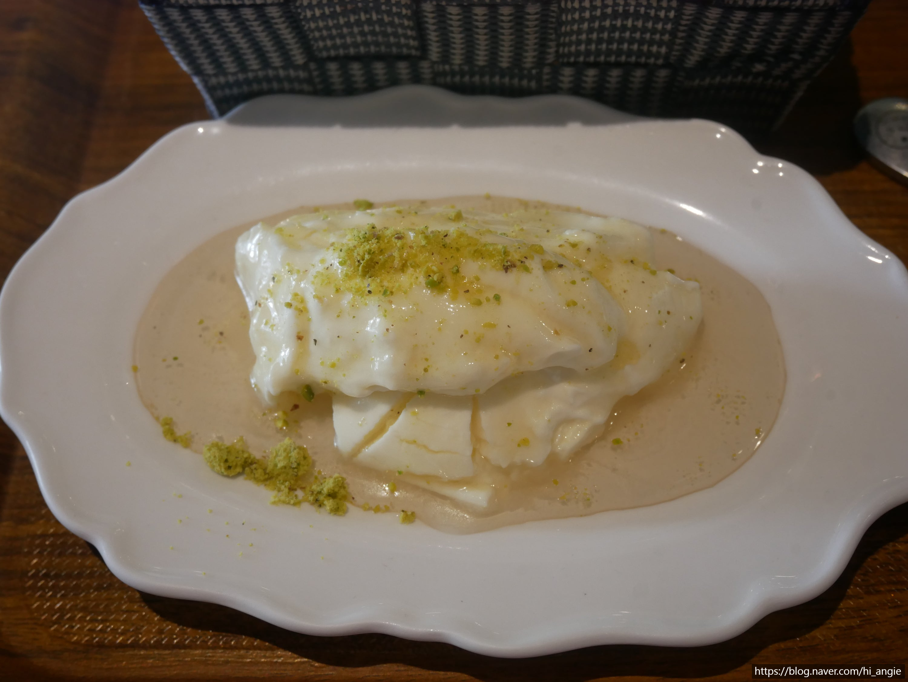 Creamy Turkish dessert topped with crushed pistachios and light syrup