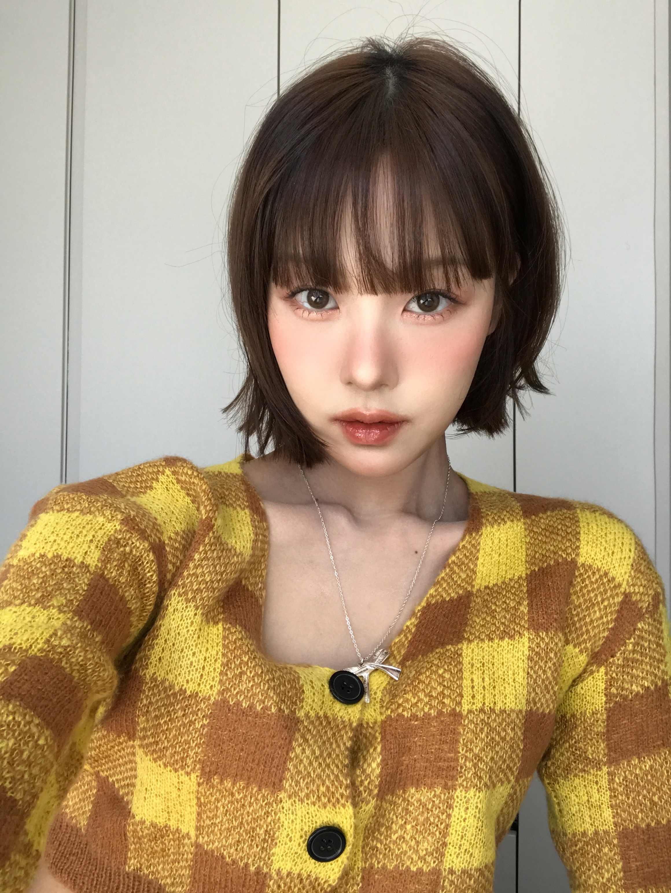 Clean chin-length short bob haircut with textured bangs