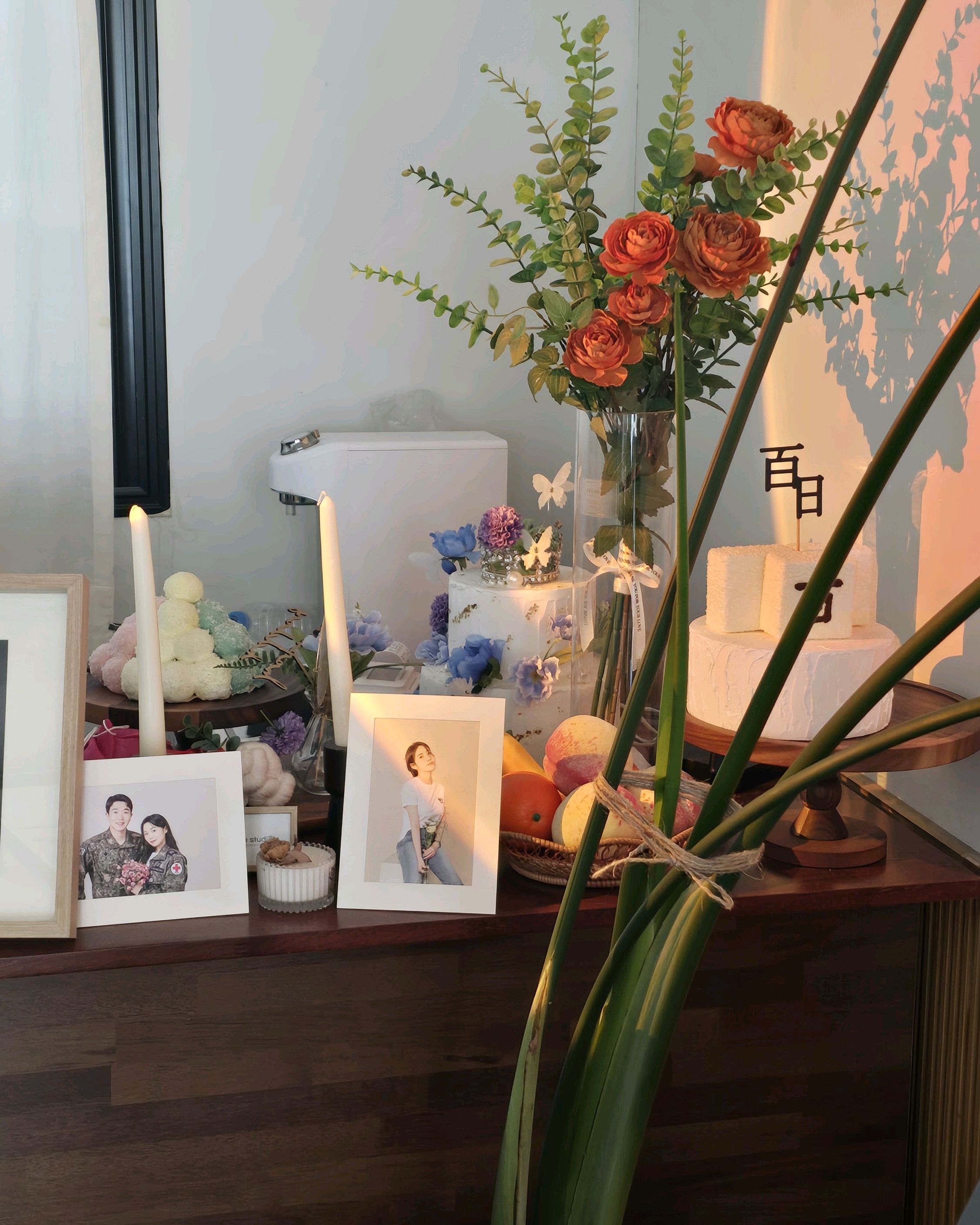Studio prop table with flowers and cakes