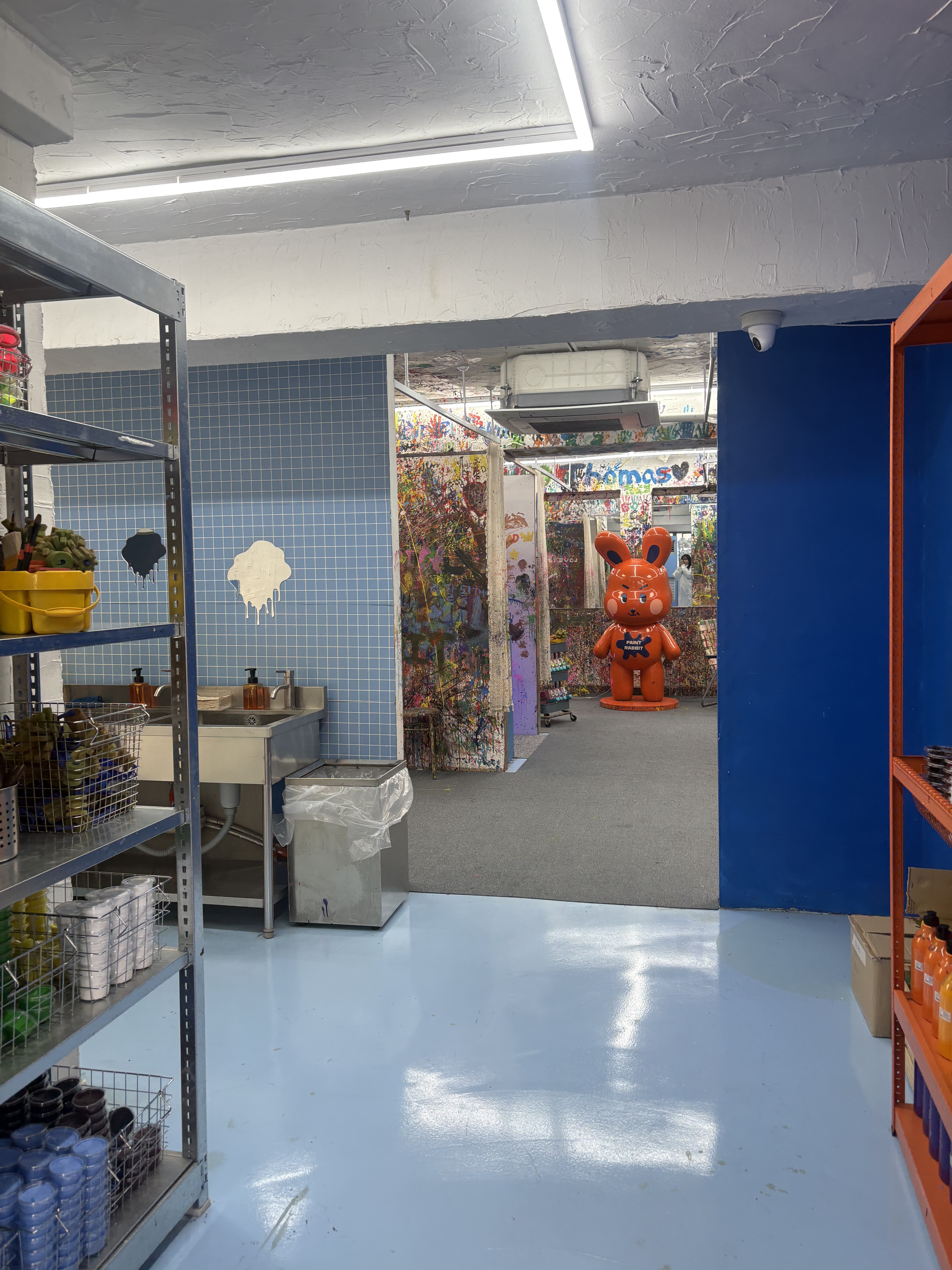 Interior of Paint Rabbit art studio in Seongsu-dong featuring a bright orange rabbit statue and paint-splattered walls