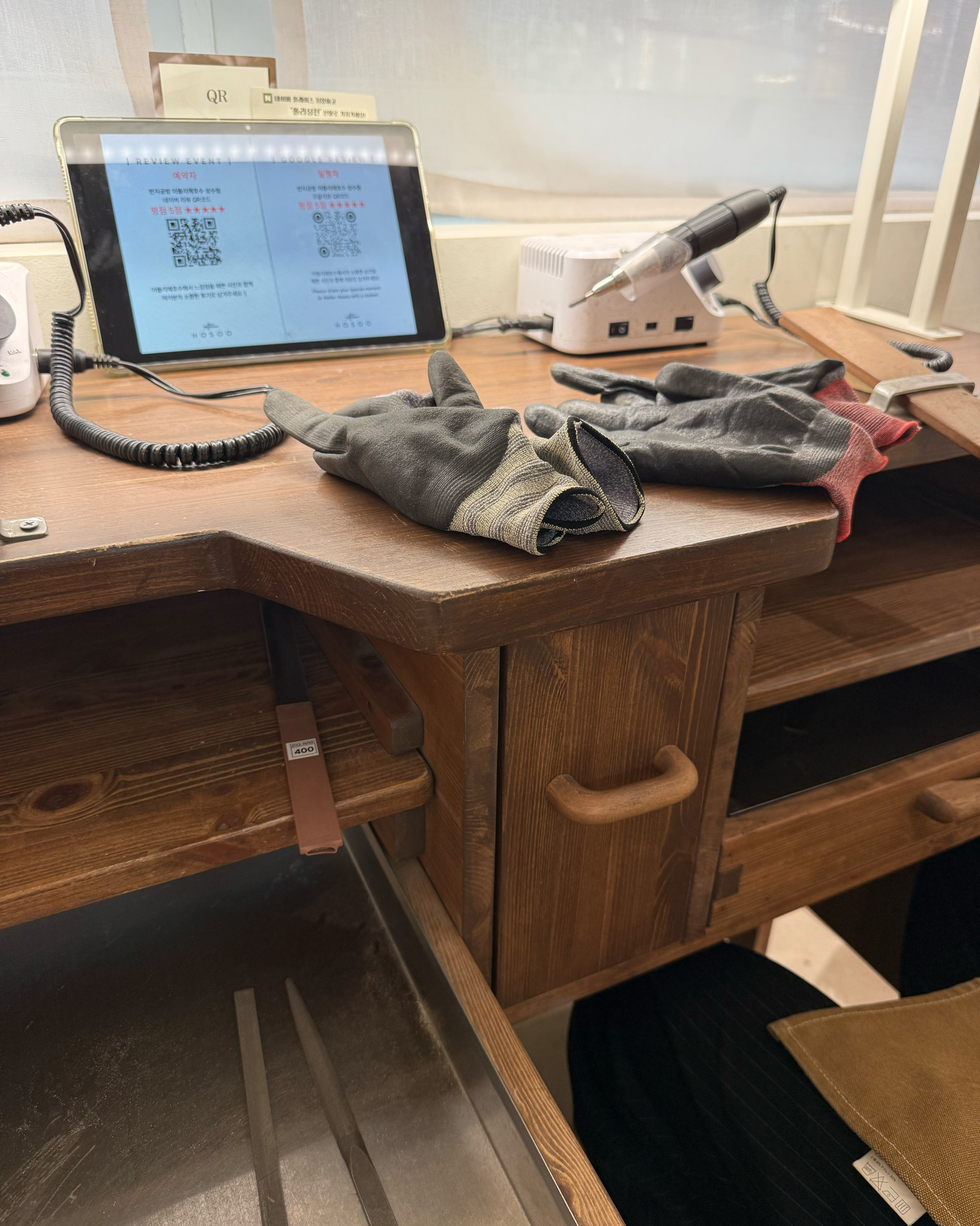 Jewelry crafting workbench with protective gloves and rotary tool