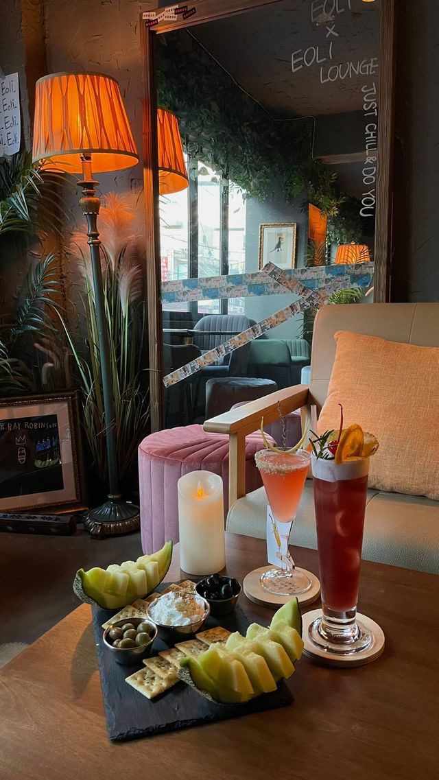 2nd Floor Basquiat-inspired lounge setting with table lamps and evening drinks