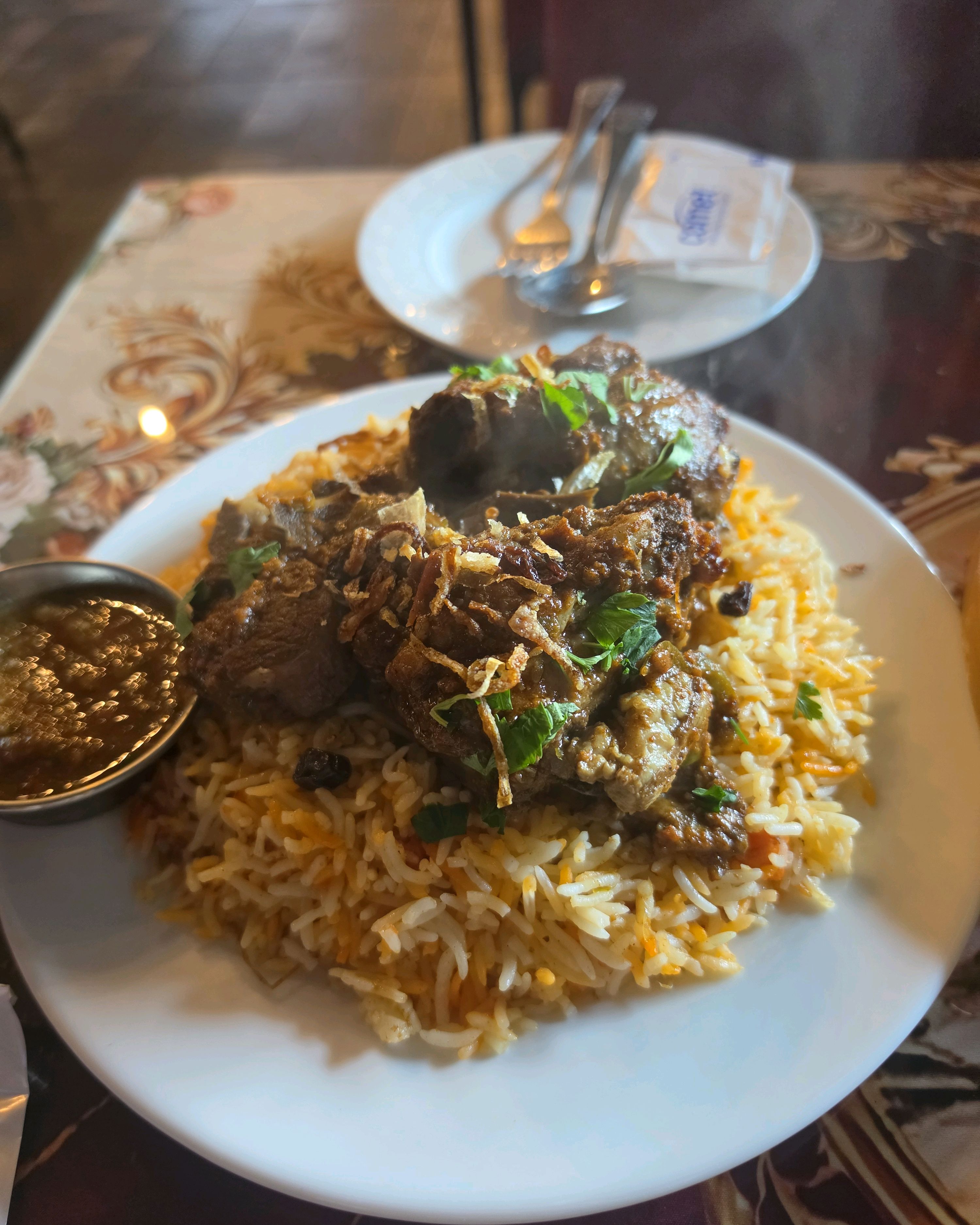 Slow-cooked Lamb Biryani with spiced saffron rice and sauce