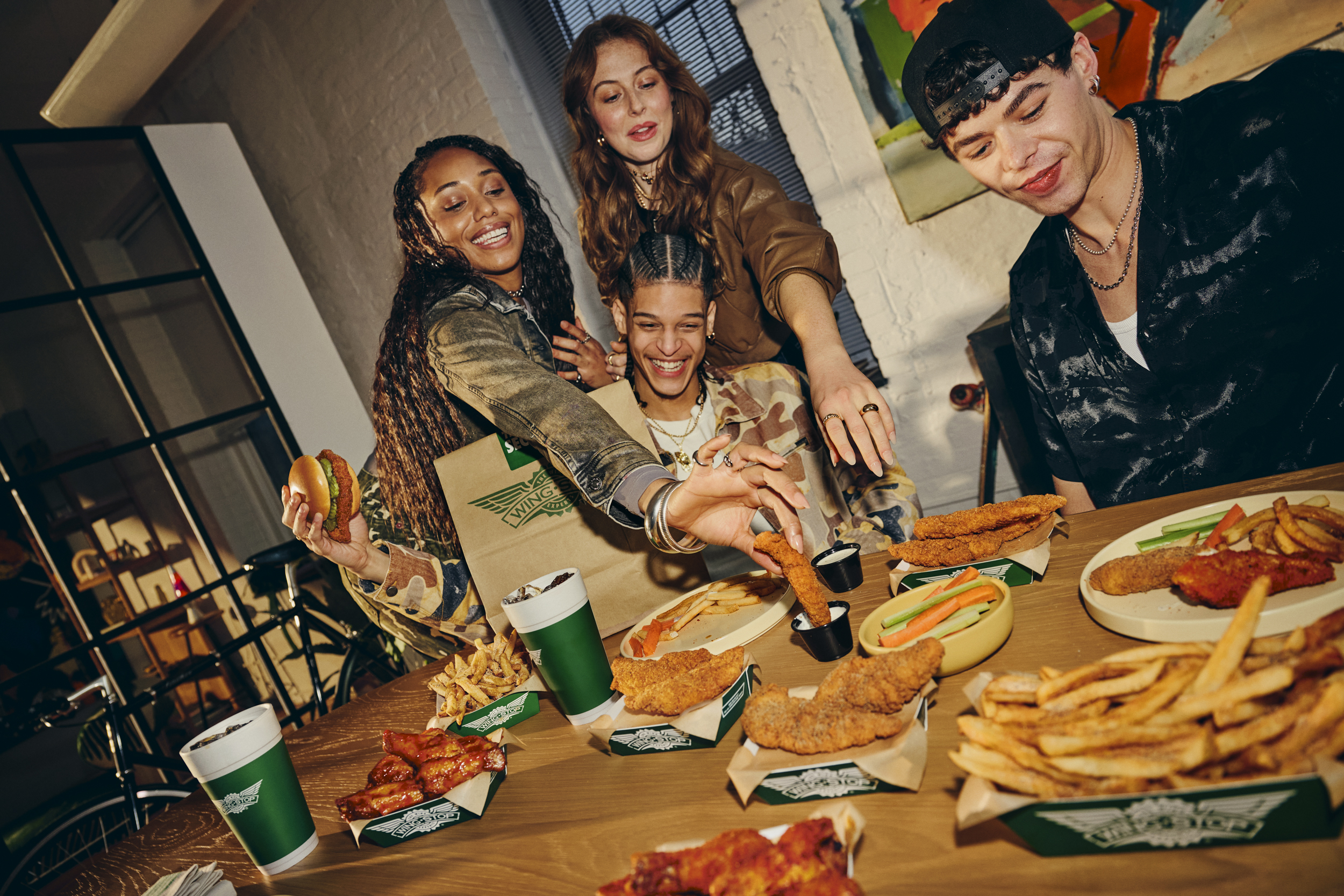 Friends dining together at Wingstop Itaewon sharing tenders and fries