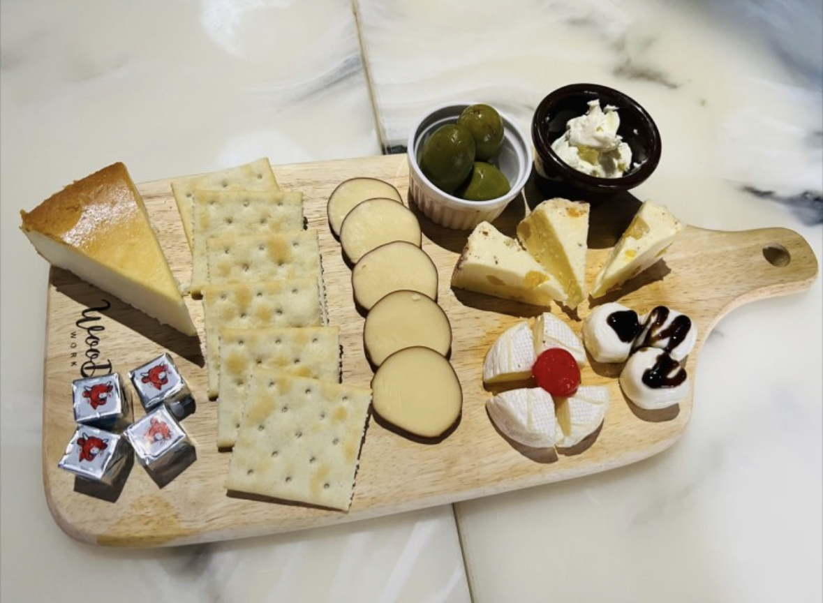 Cheese and cracker charcuterie board with olives