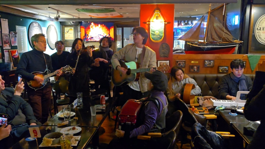 Live folk music session inside the dark wood pub interior