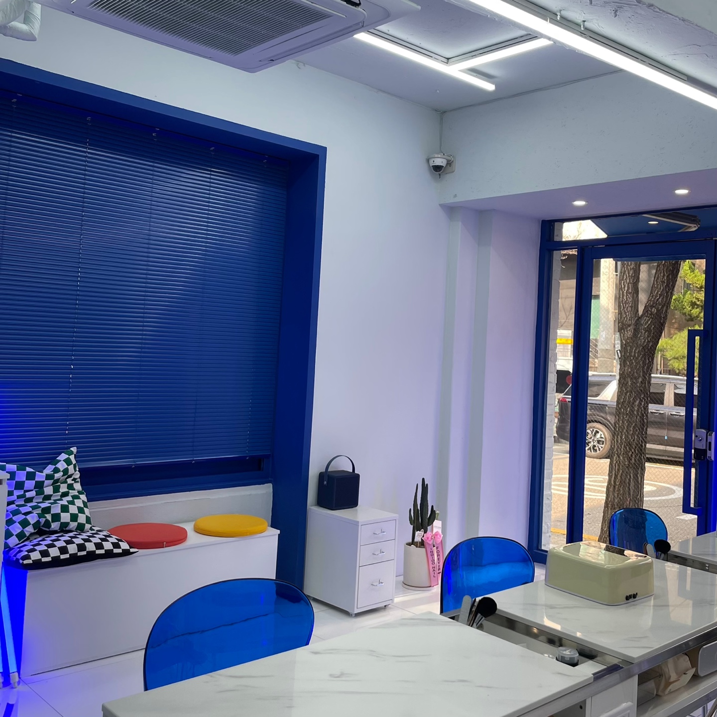 Bright, welcoming interior view of Nail Indigo lounge area and manicure stations