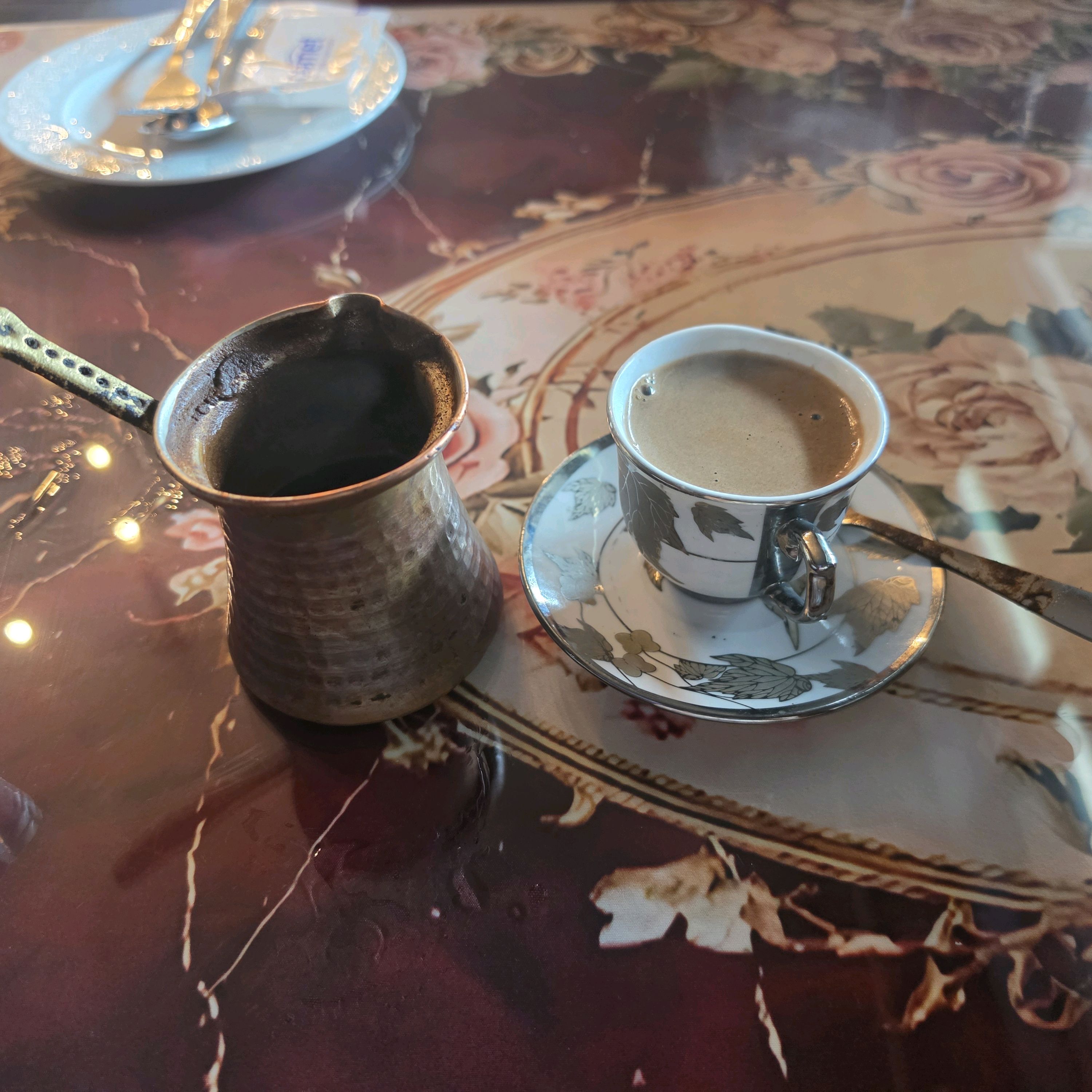 Traditional Turkish Cezve coffee service in ornate copper pot