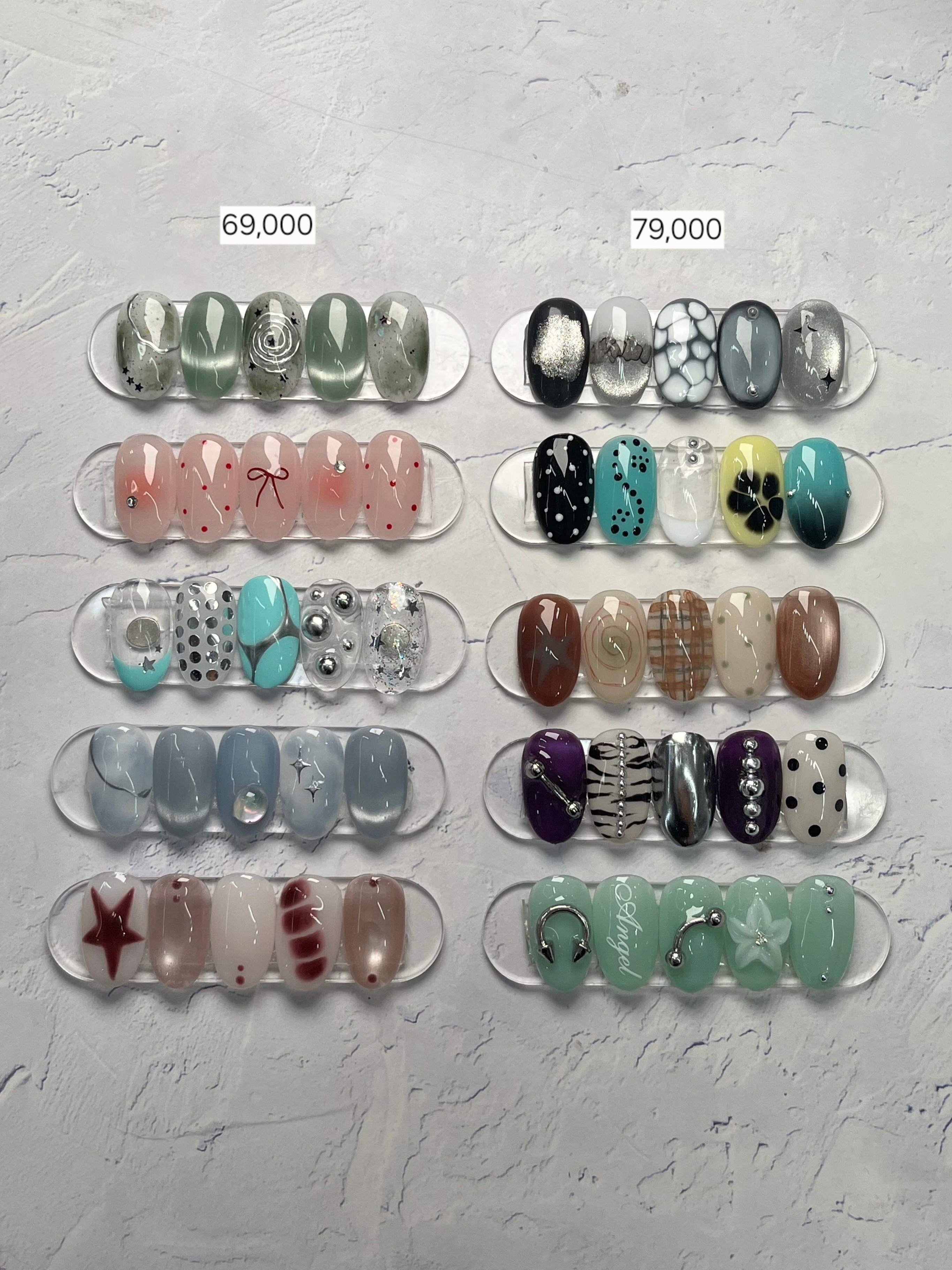 Display of artificial nail art samples arranged with curated seasonal palettes and embellishments.