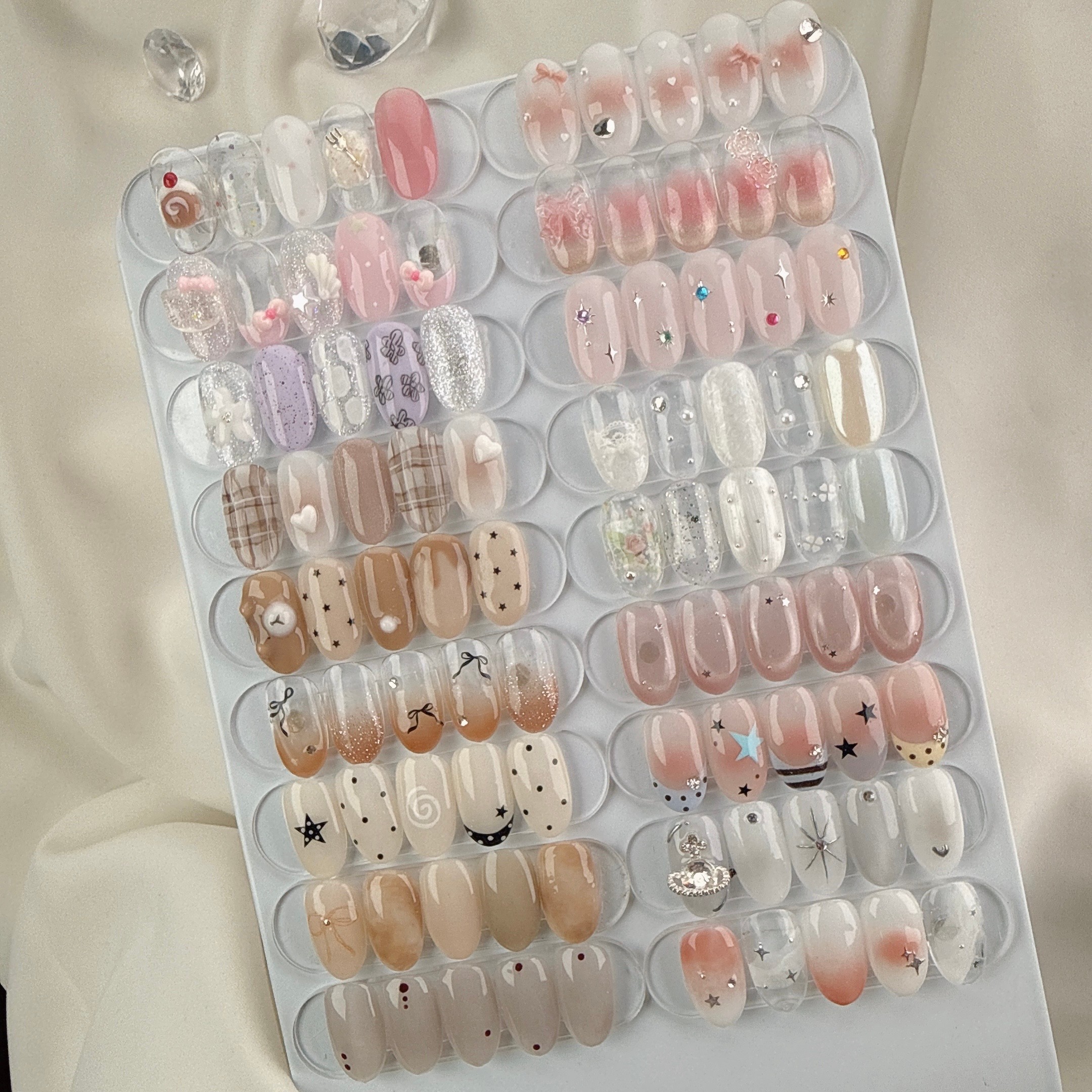 Curated sample display board showing Monthly Art gel designs and embellishments