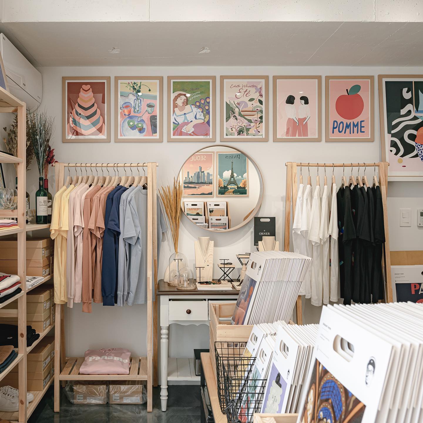 Interior of Bank Holiday interior decor shop featuring framed art, clothing racks, and organized goods in Seoul