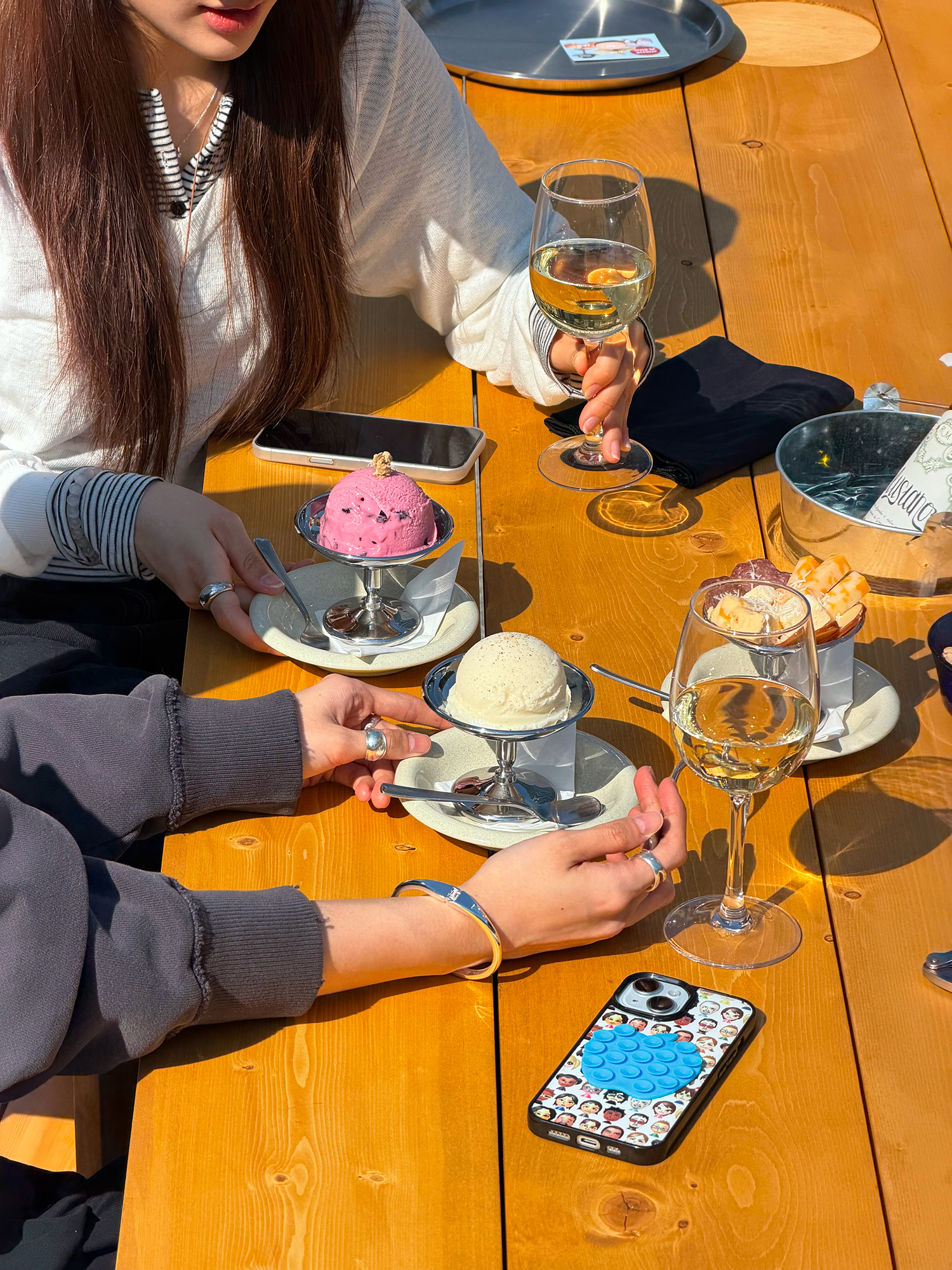 Guests enjoying glass wine and ice cream pairings at an outdoor terrace table