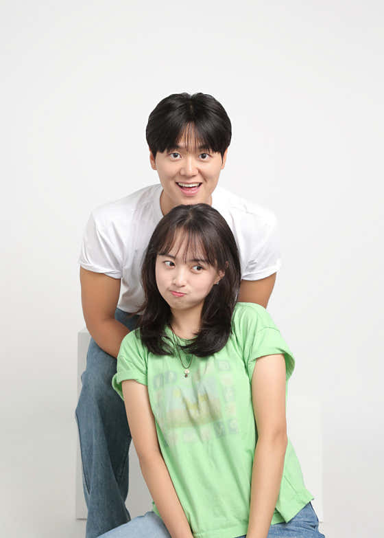 Studio portrait of two people posing closely