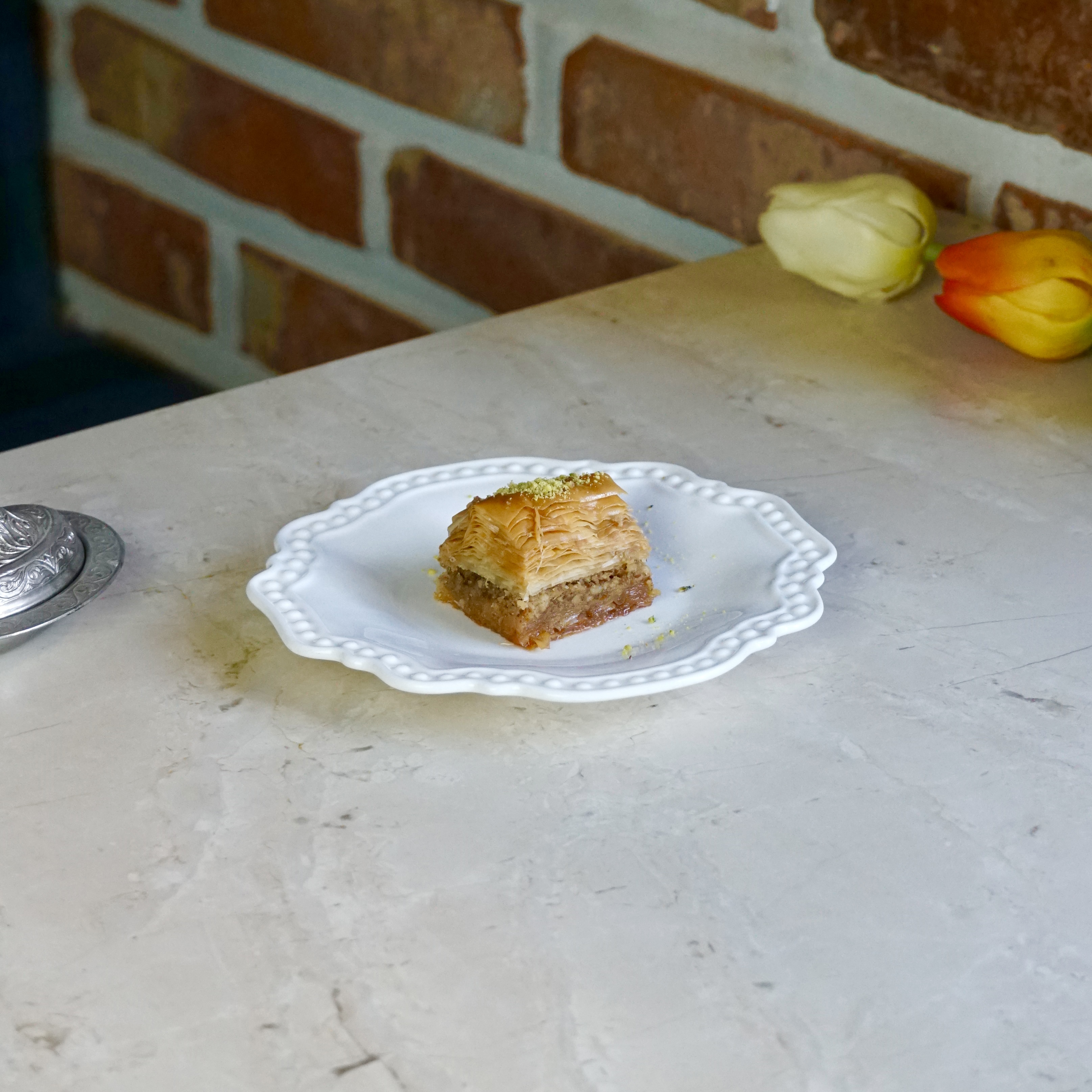Crispy Gaziantep pistachio baklava served on an ornate porcelain plate