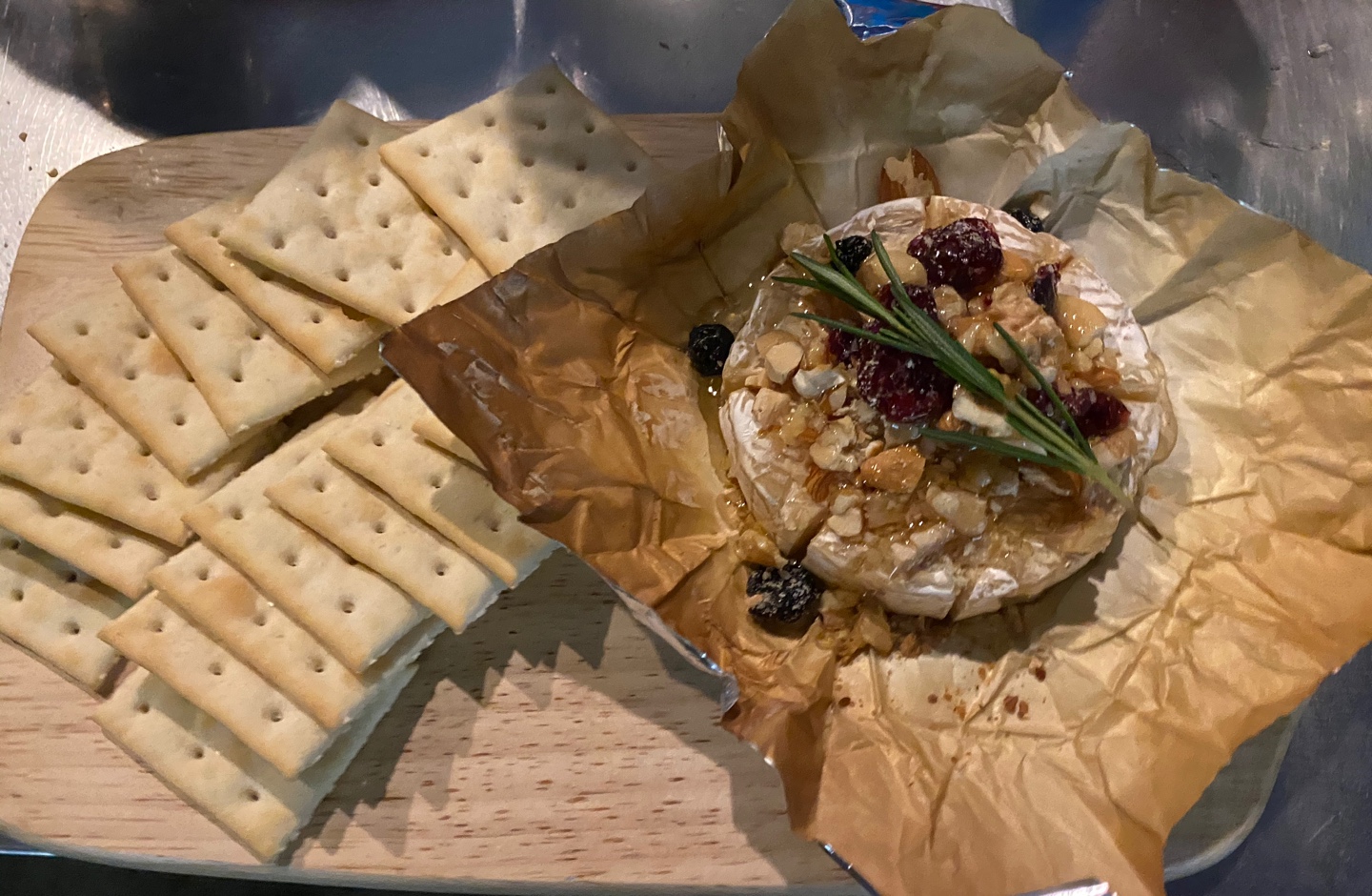 Warm baked brie platter topped with nuts and berries