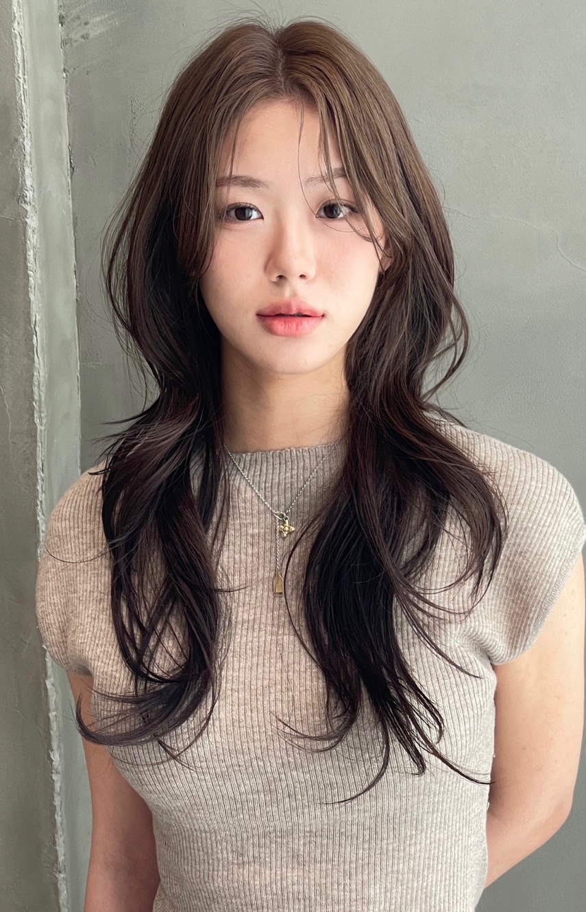 Long layered wavy dark brown hair styling with soft movement