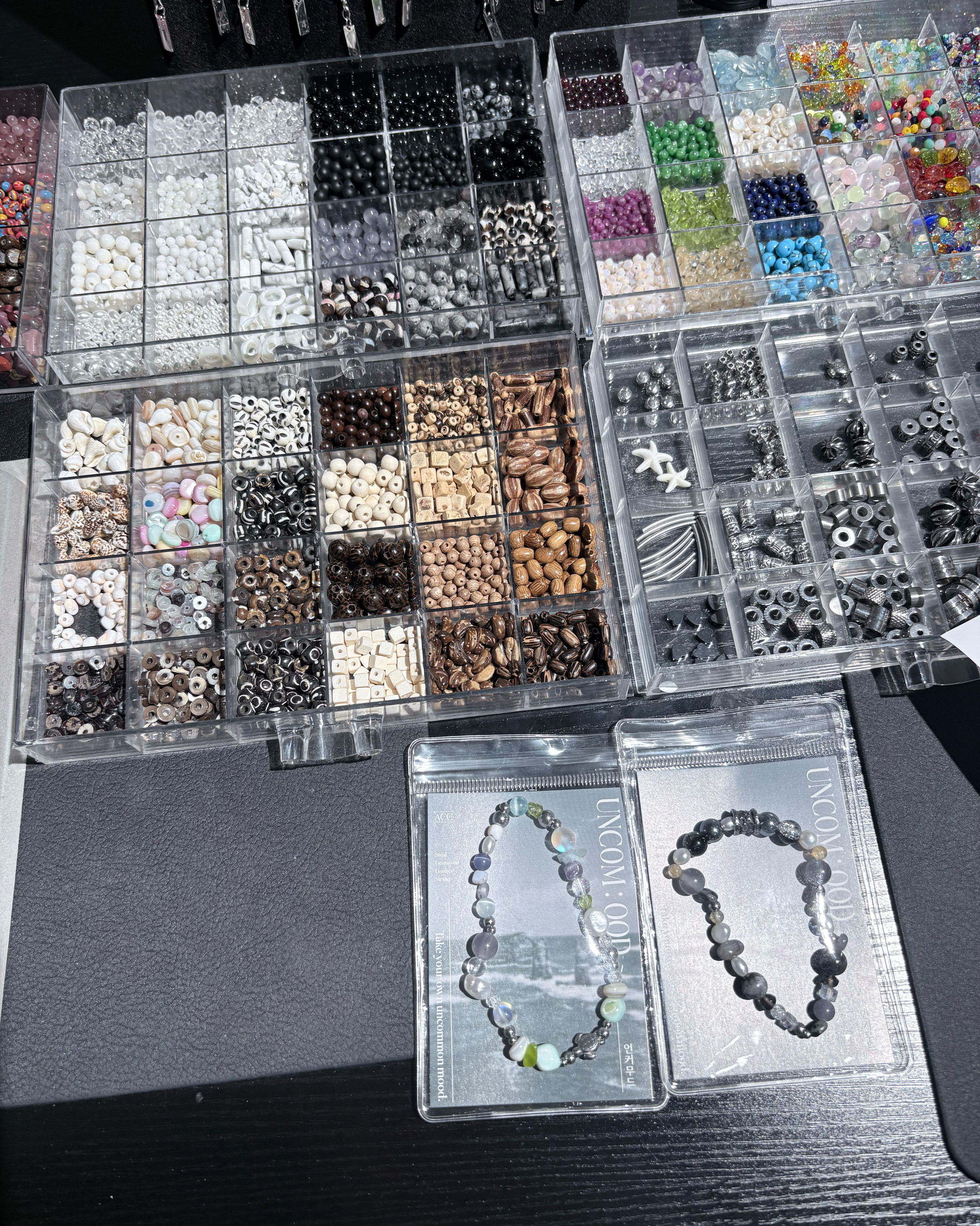Organized trays of gemstone beads and natural stones