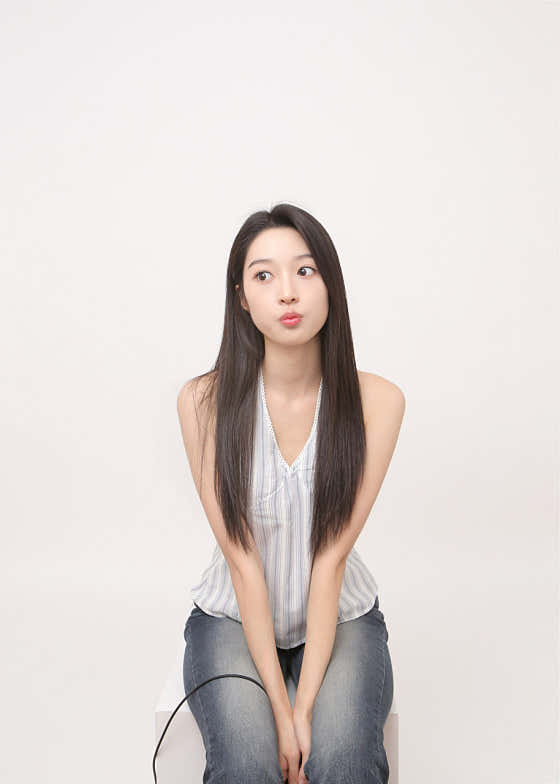 Solo portrait sitting on studio white block