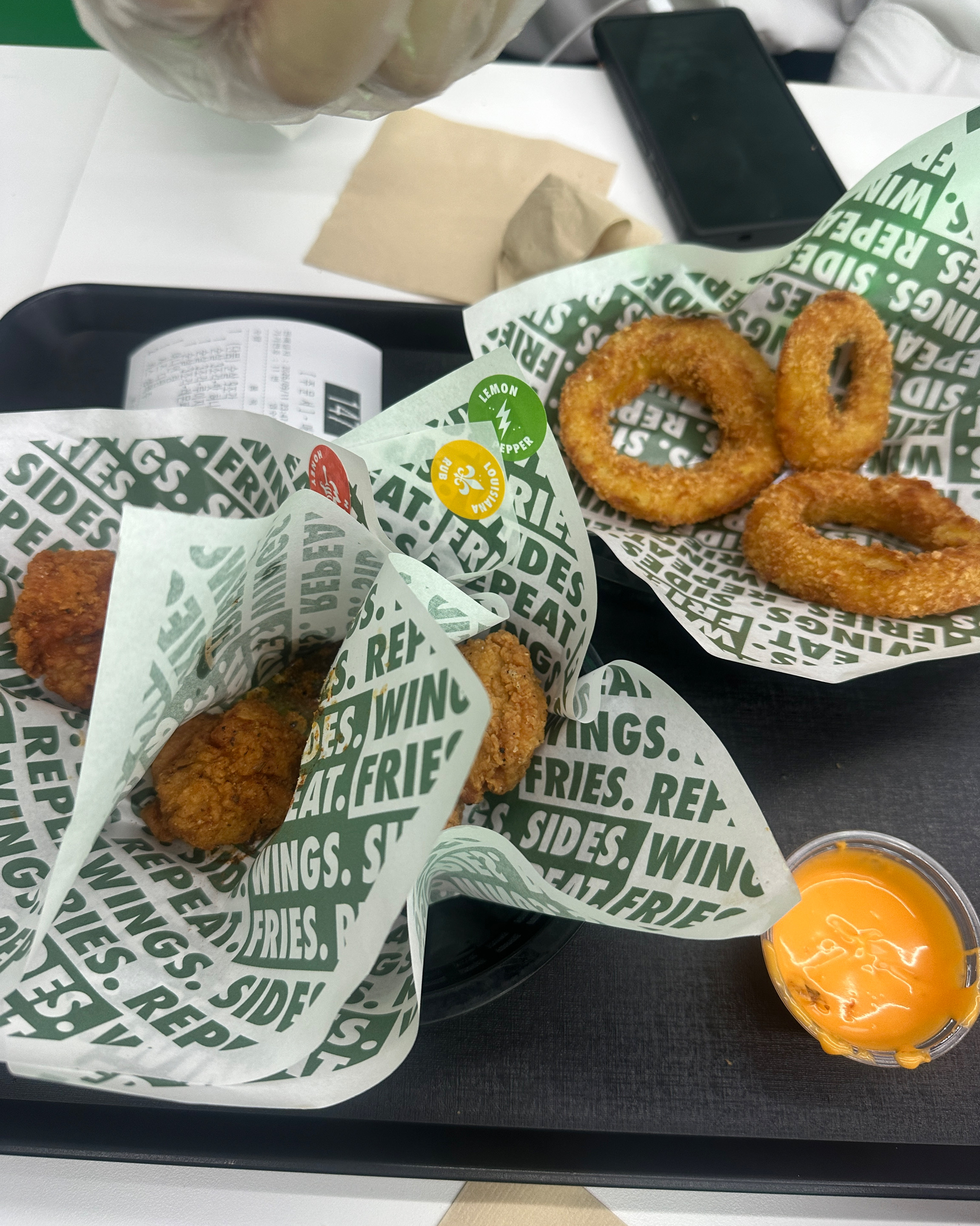Chicken combo tray with crispy onion rings and dipping sauce