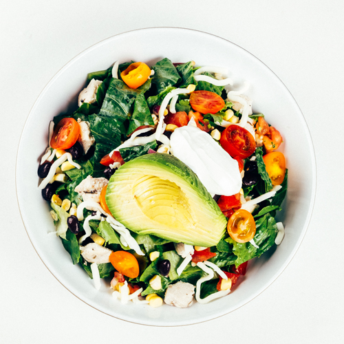 Salad bowl with chicken, avocado, black beans, and corn