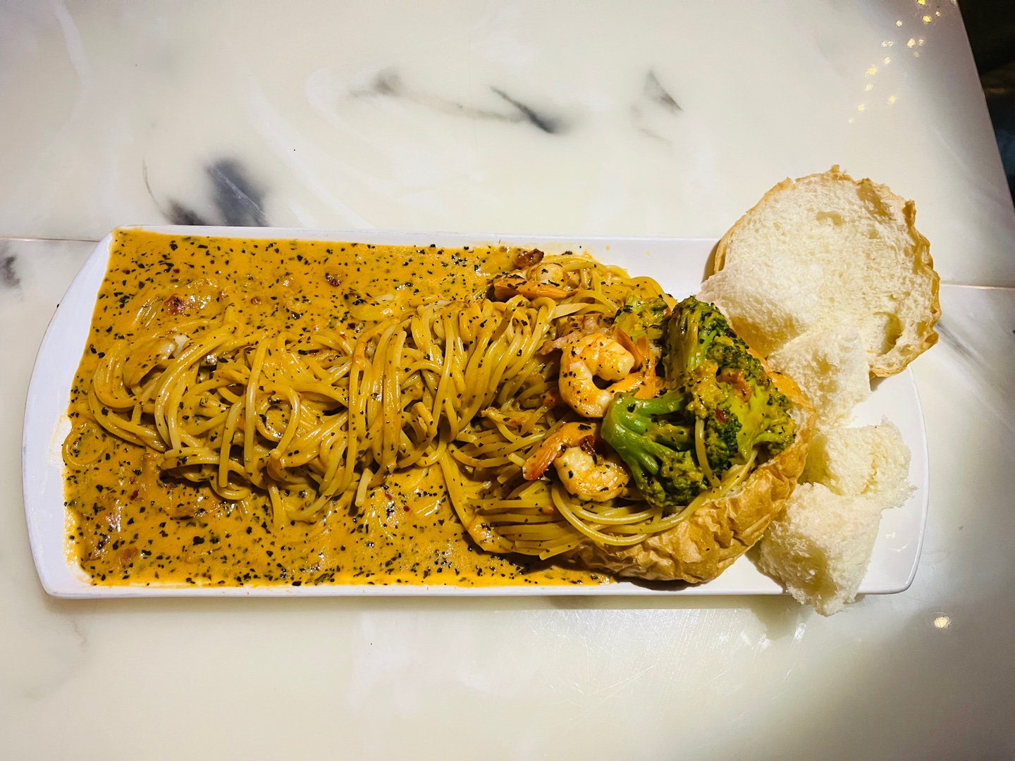 Cream pasta with shrimp and toasted bread slices