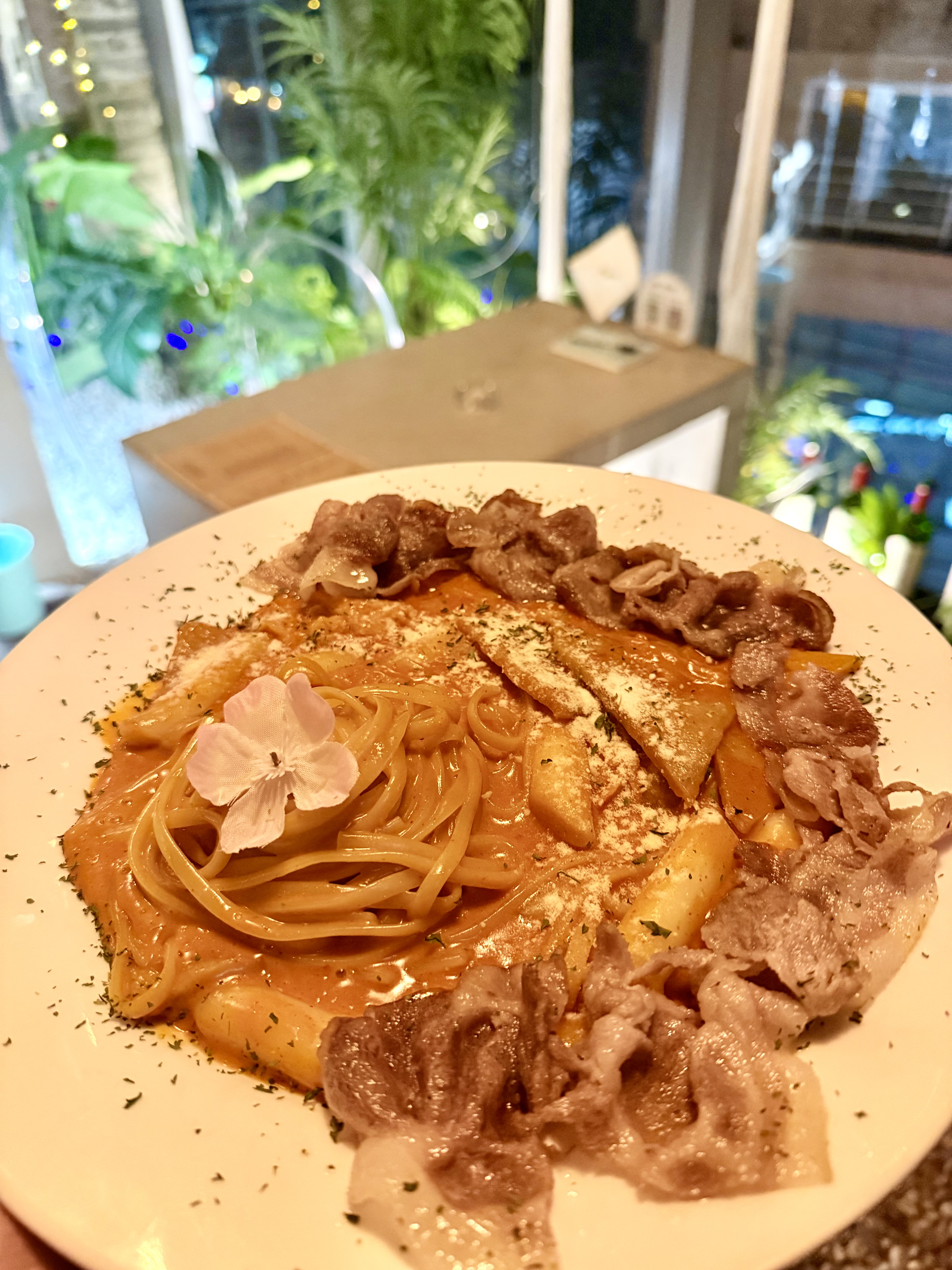 Rose tteokbokki with pasta ribbons and sliced meat