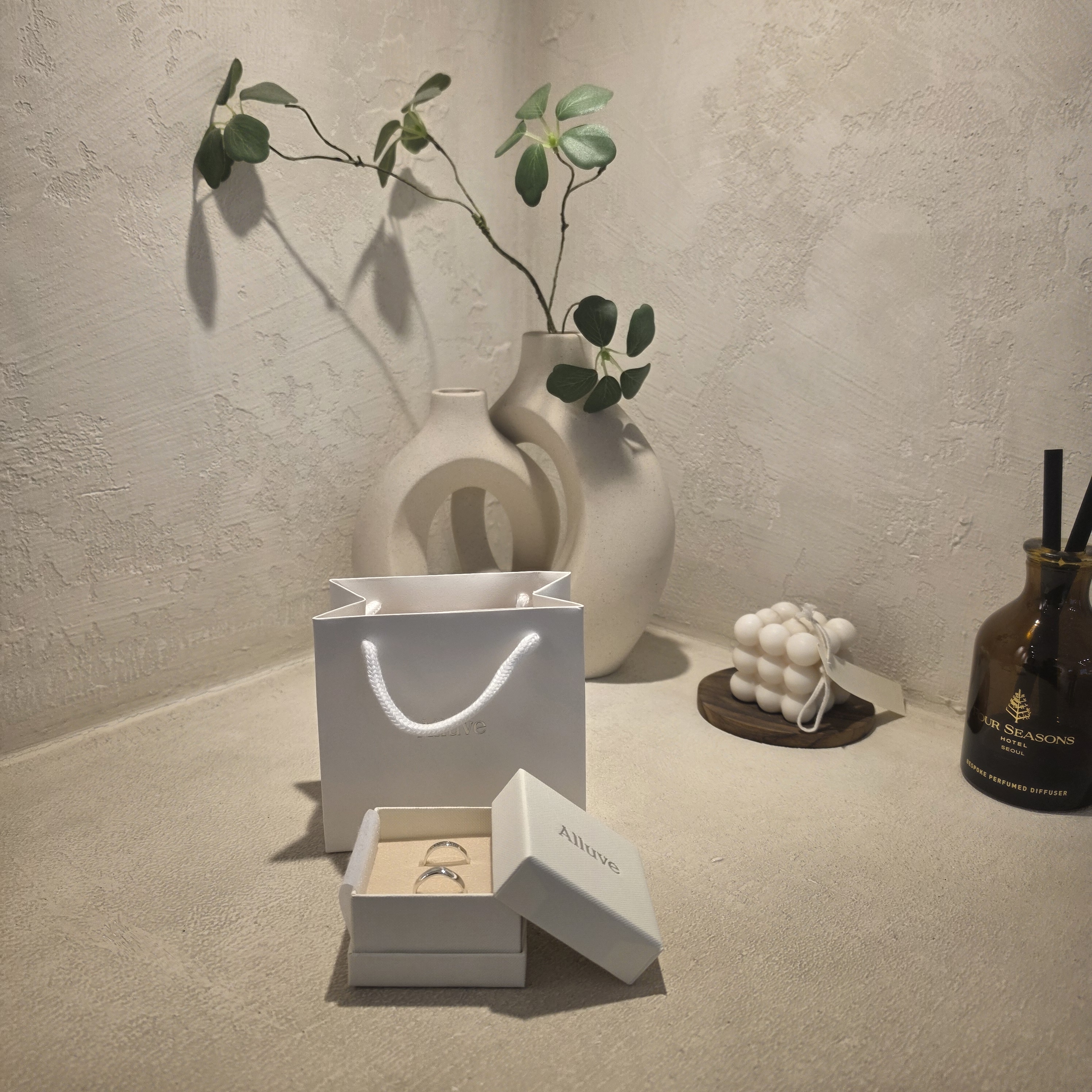 Alluve branded white presentation gift box and paper bag with custom silver rings