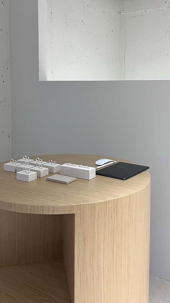 Minimalist display table with jewelry stands at Noimoi studio in Yeonnam-dong.
