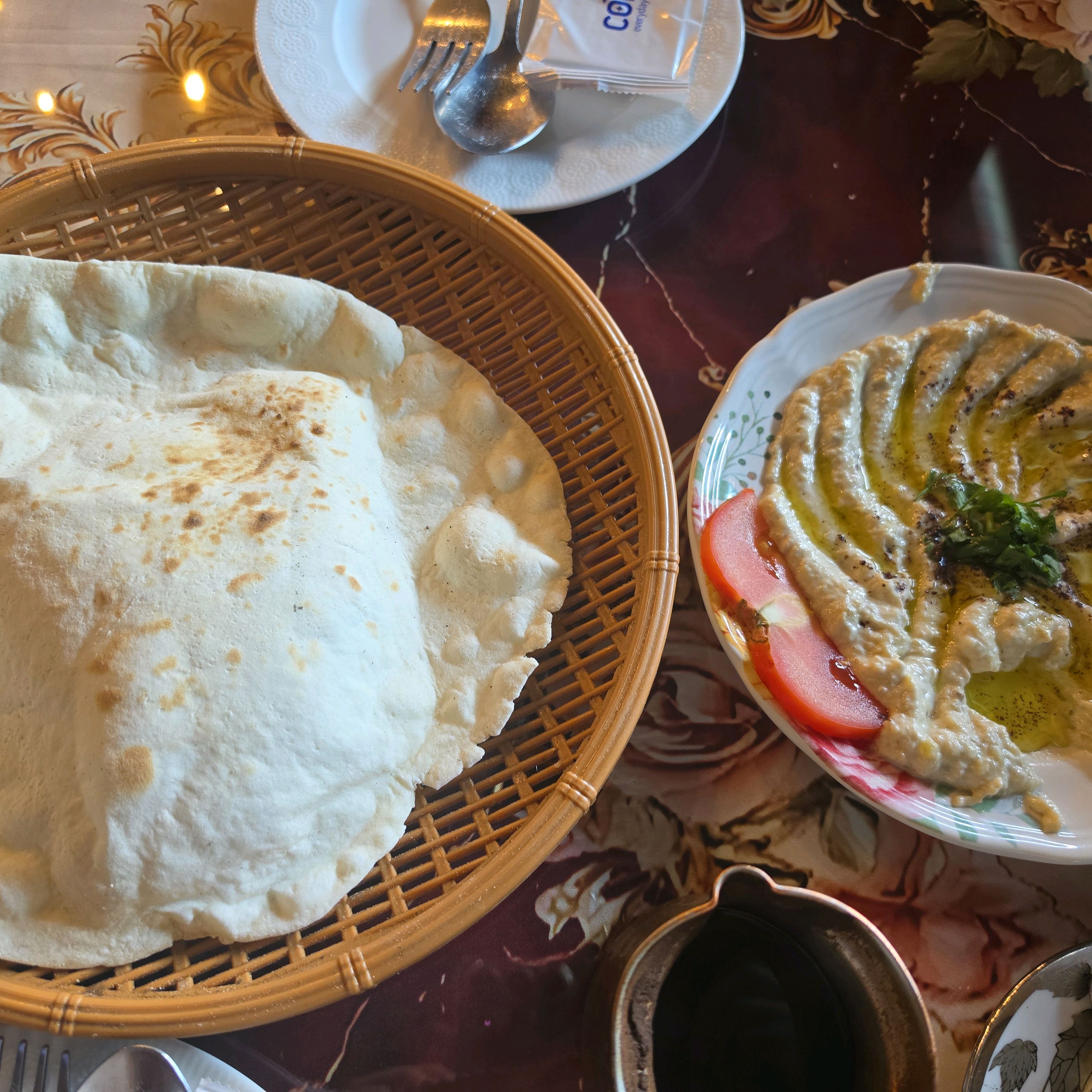 Fresh hearth flatbread served in woven basket with savory meze dip