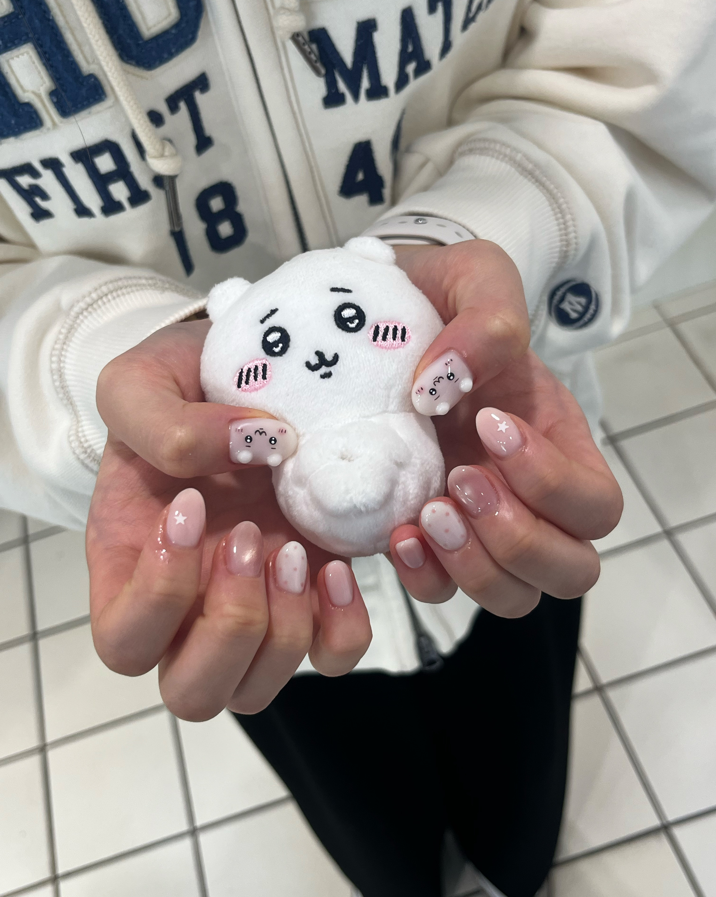 Custom character nail art featuring soft pink tones and star details