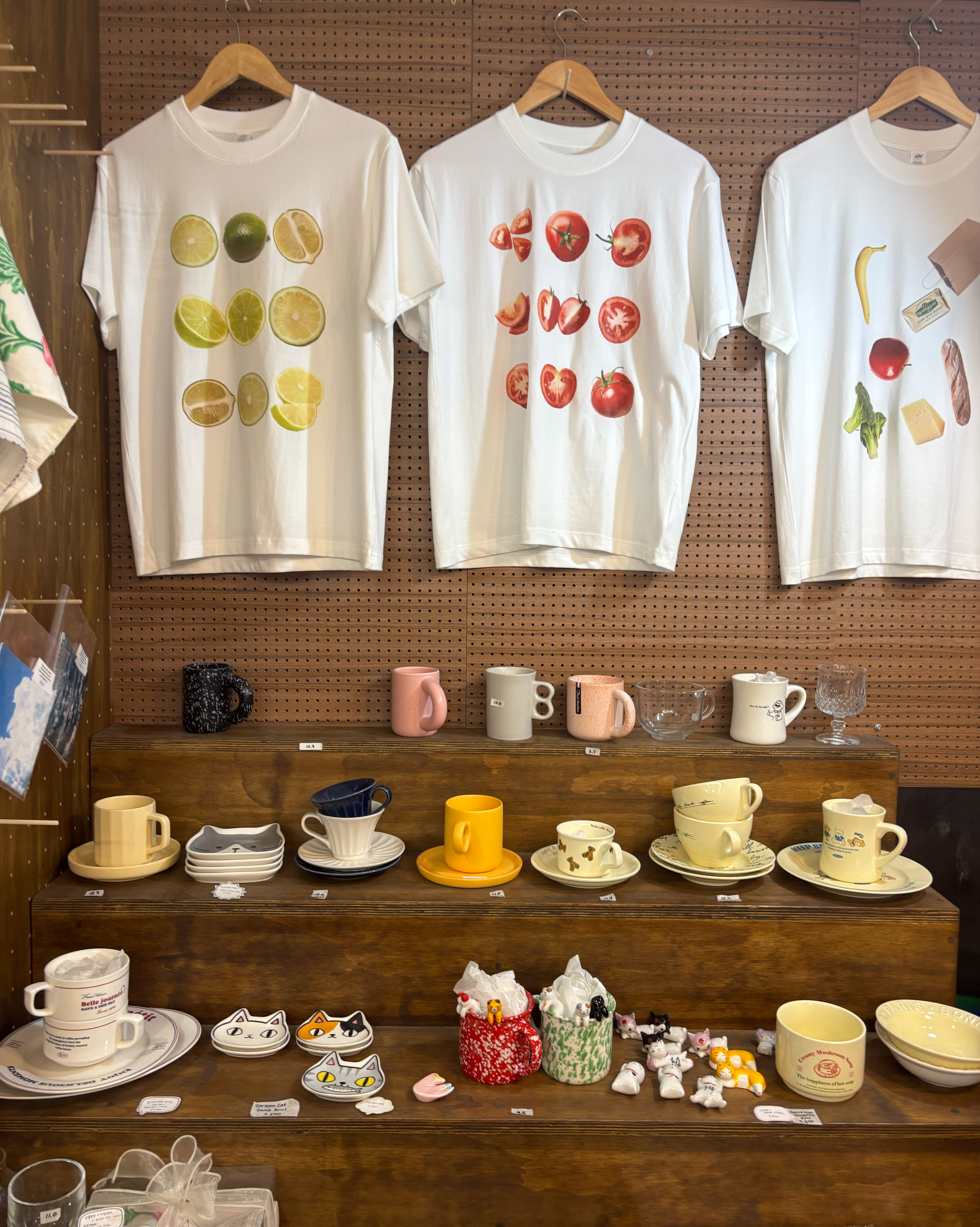 Graphic t-shirts and tiered shelves with ceramic tableware