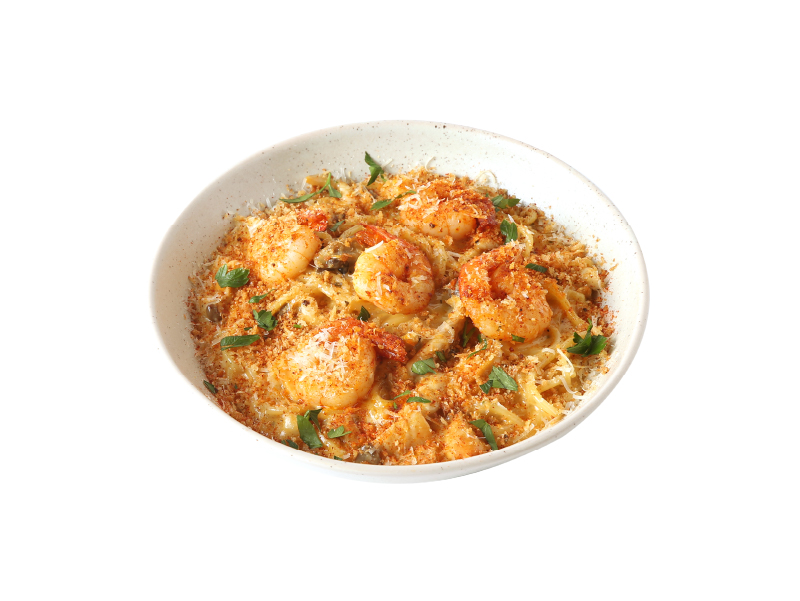 Savory shrimp pasta topped with toasted breadcrumbs, shaved cheese, and herbs
