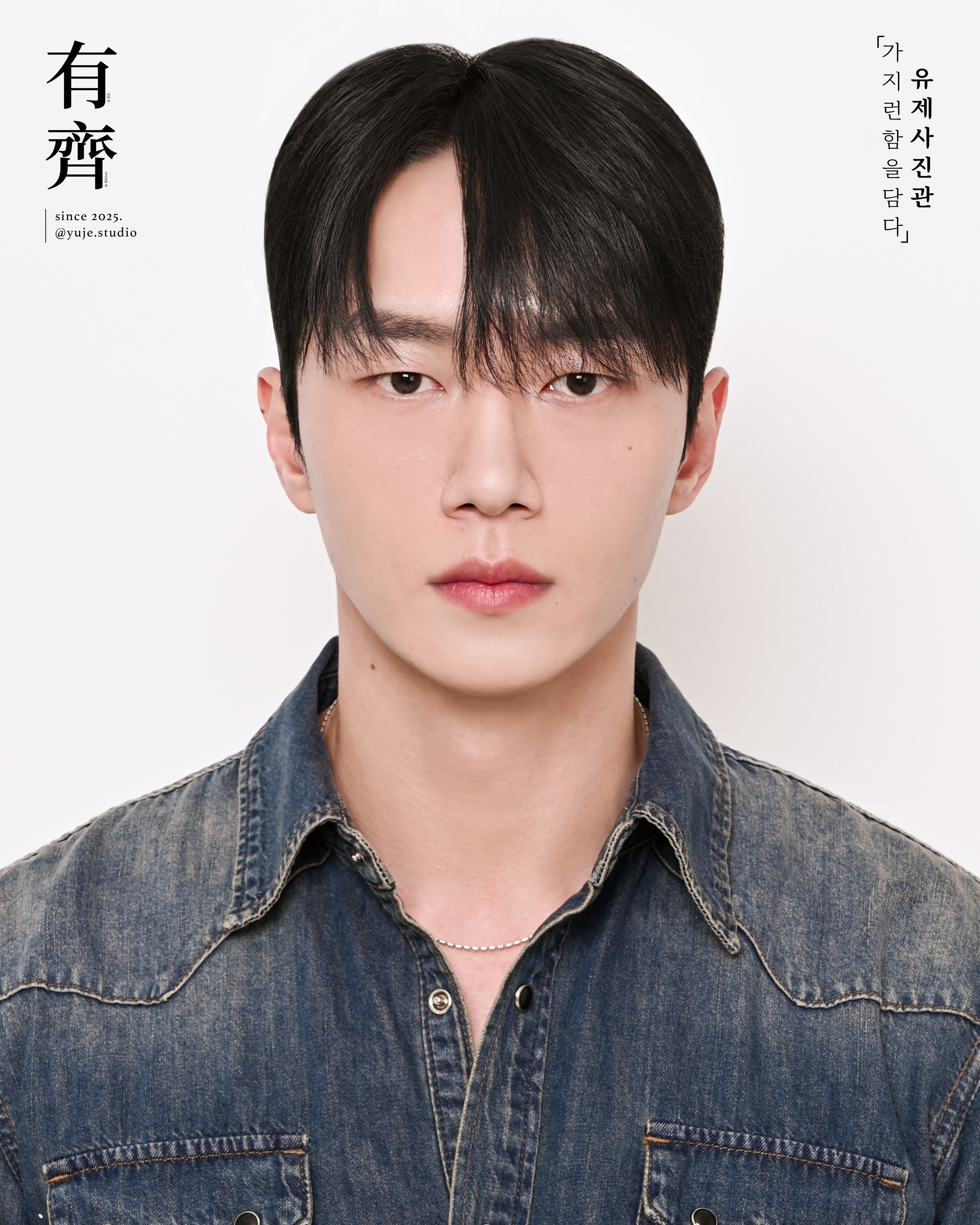 Male studio headshot portrait in denim shirt with neutral background
