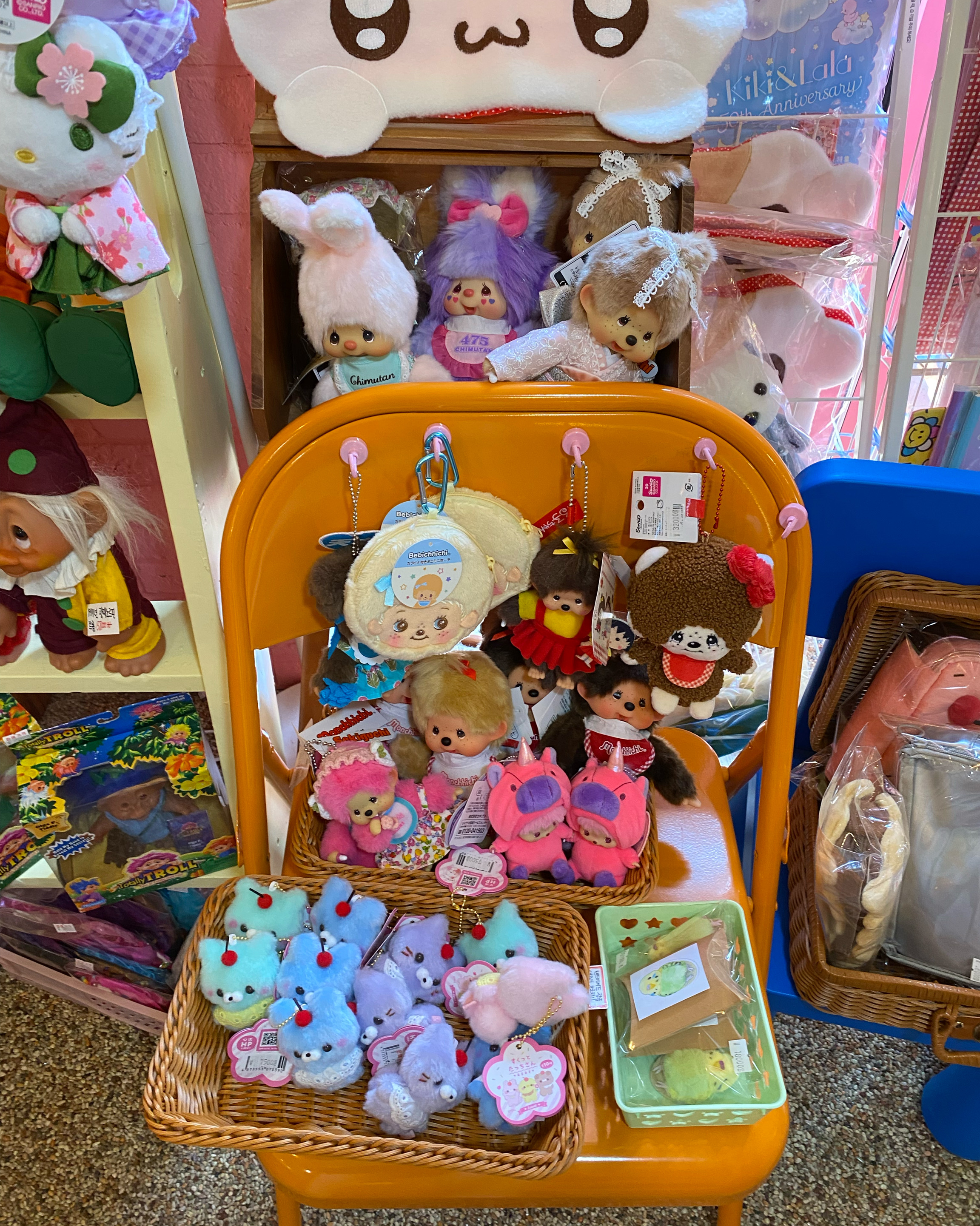 Plush charms displayed on an orange chair